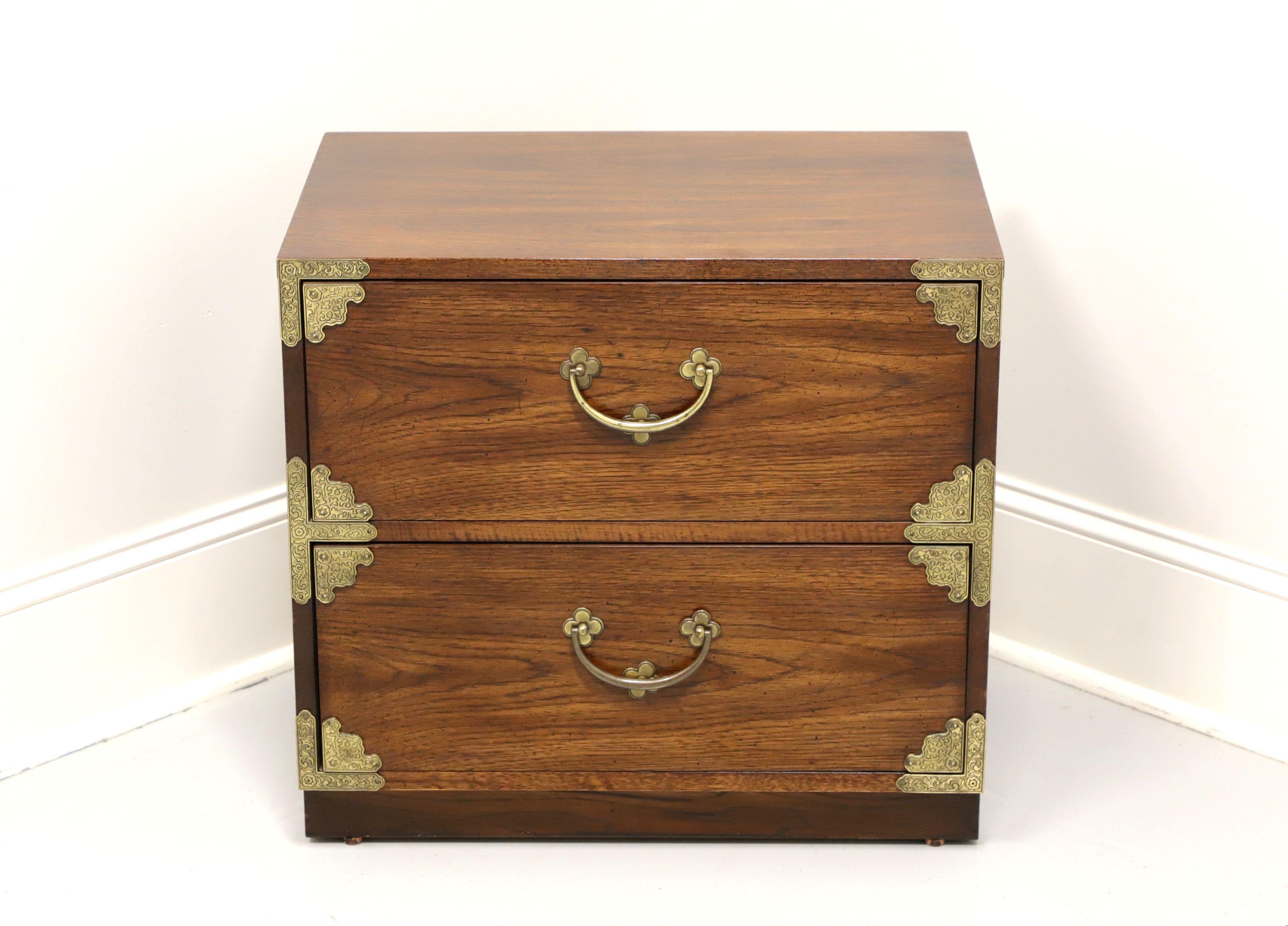 A bedside chest in the Japanese Tansu Campaign style by Huntley Thomasville. Walnut with brass hardware and decorative accents. Features two drawers of dovetail construction. Made in North Carolina, USA, in the mid 20th Century.

Measures: 21 W 16