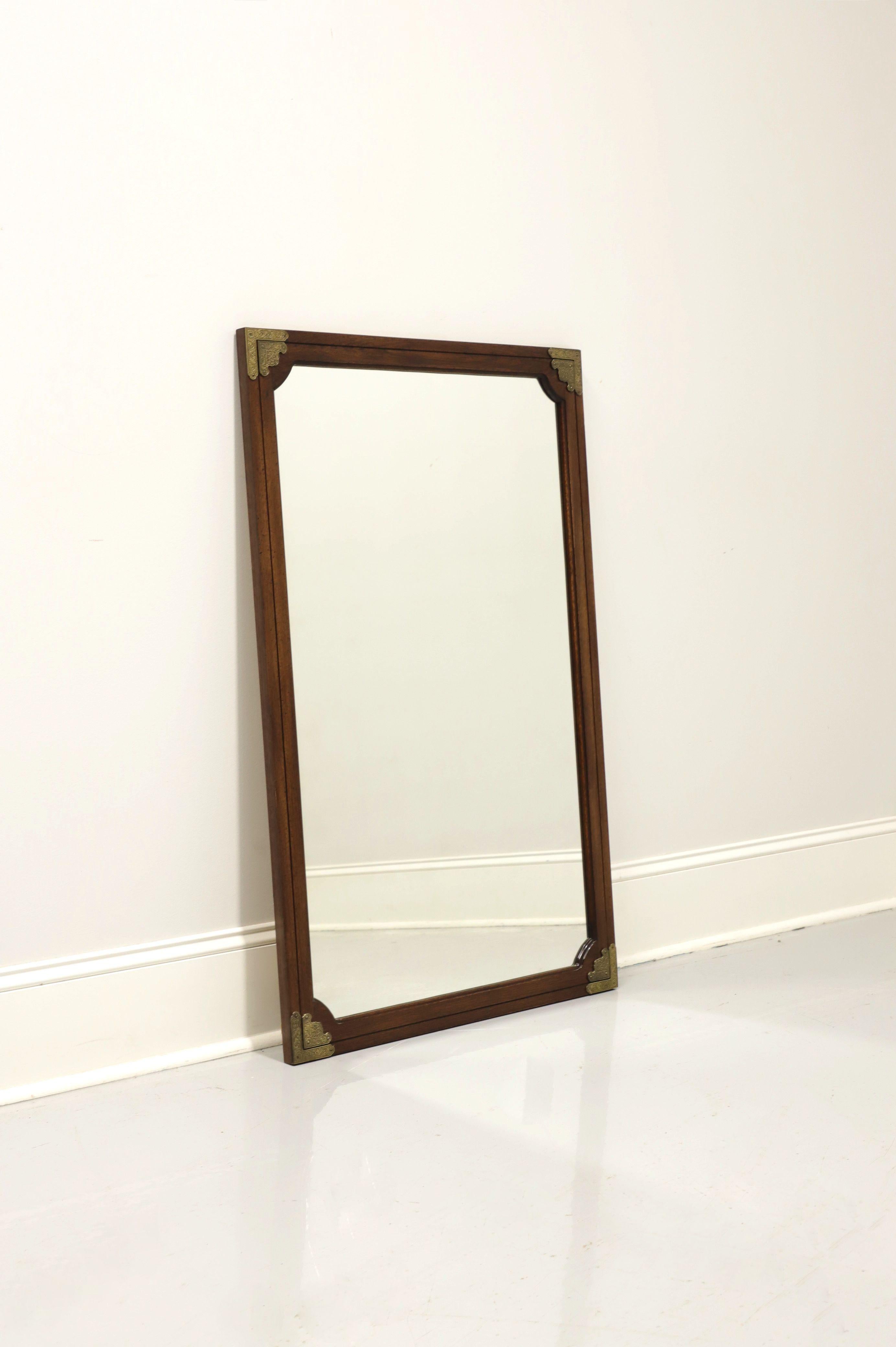 A Japanese Tansu Campaign style wall mirror by Huntley Thomasville. Mirror glass and rectangular banded walnut frame with decorative brass accents. Made in North Carolina, USA, in the mid 20th Century.

Measures: 27.25 W 1 D 43.25 H, Weighs