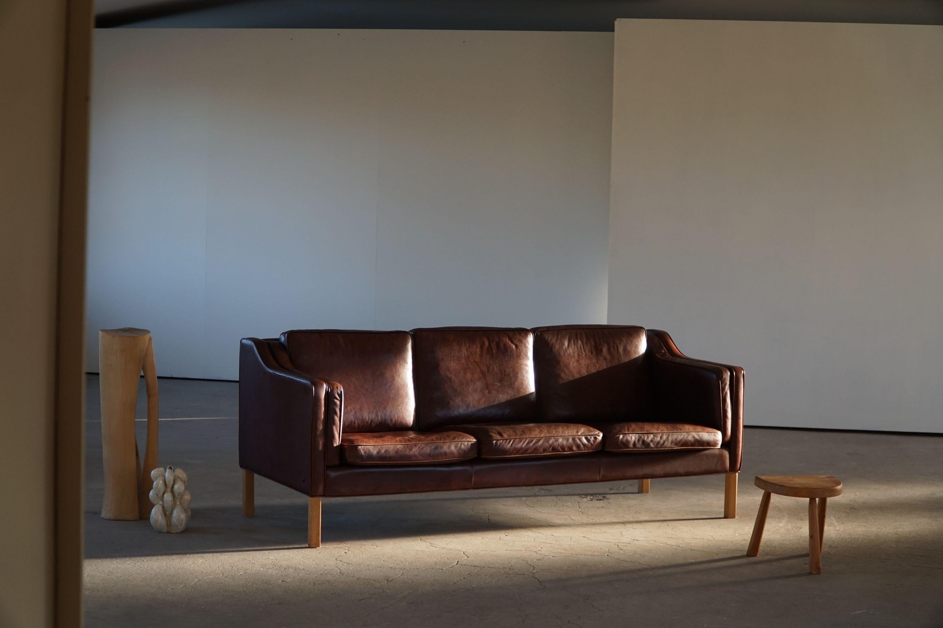 A classic Danish Mordern 3-seater sofa in brown leather, feets made in solid beech. Simple lines and a great comfort featured in this sofa. Designed by Hurup Møbelfabrik, Denmark. Made in 1970s.

This beautiful sofa will complement many interior