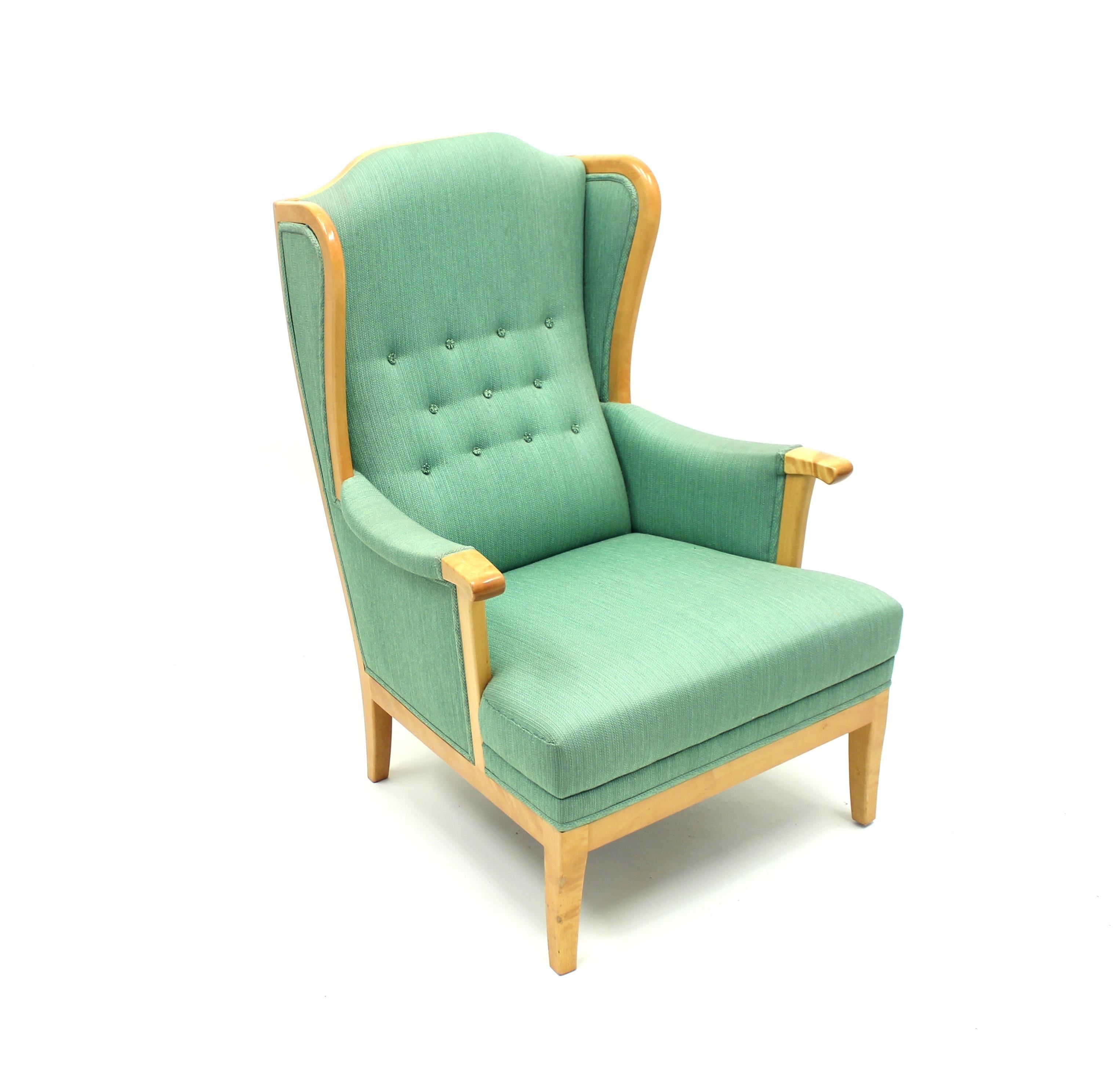 Lounge chair, model Husfadern (The house father), designed by Carl Malmsten for his long-time collaborator O.H. Sjögren. Original green Carl Malmsten fabric, sits on a lacquered birch frame. Ware consistent with age and use.