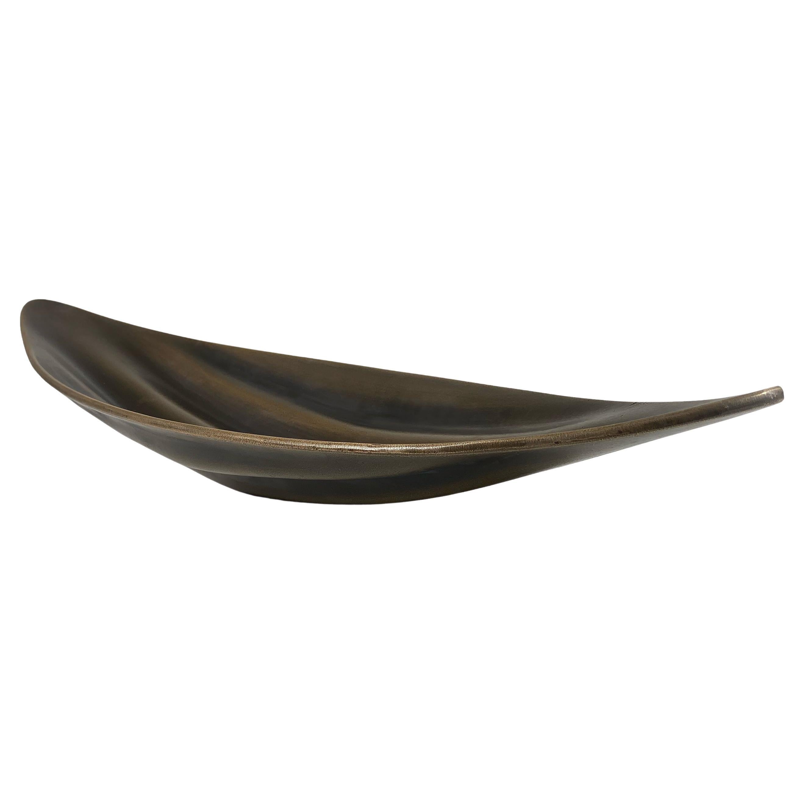 The Husk Display Plate represents both form and function, making it a stunning addition to any home. Crafted from solid bronze, this piece boasts a beautifully weighted design that exudes timeless elegance. With its unique and striking aesthetic,