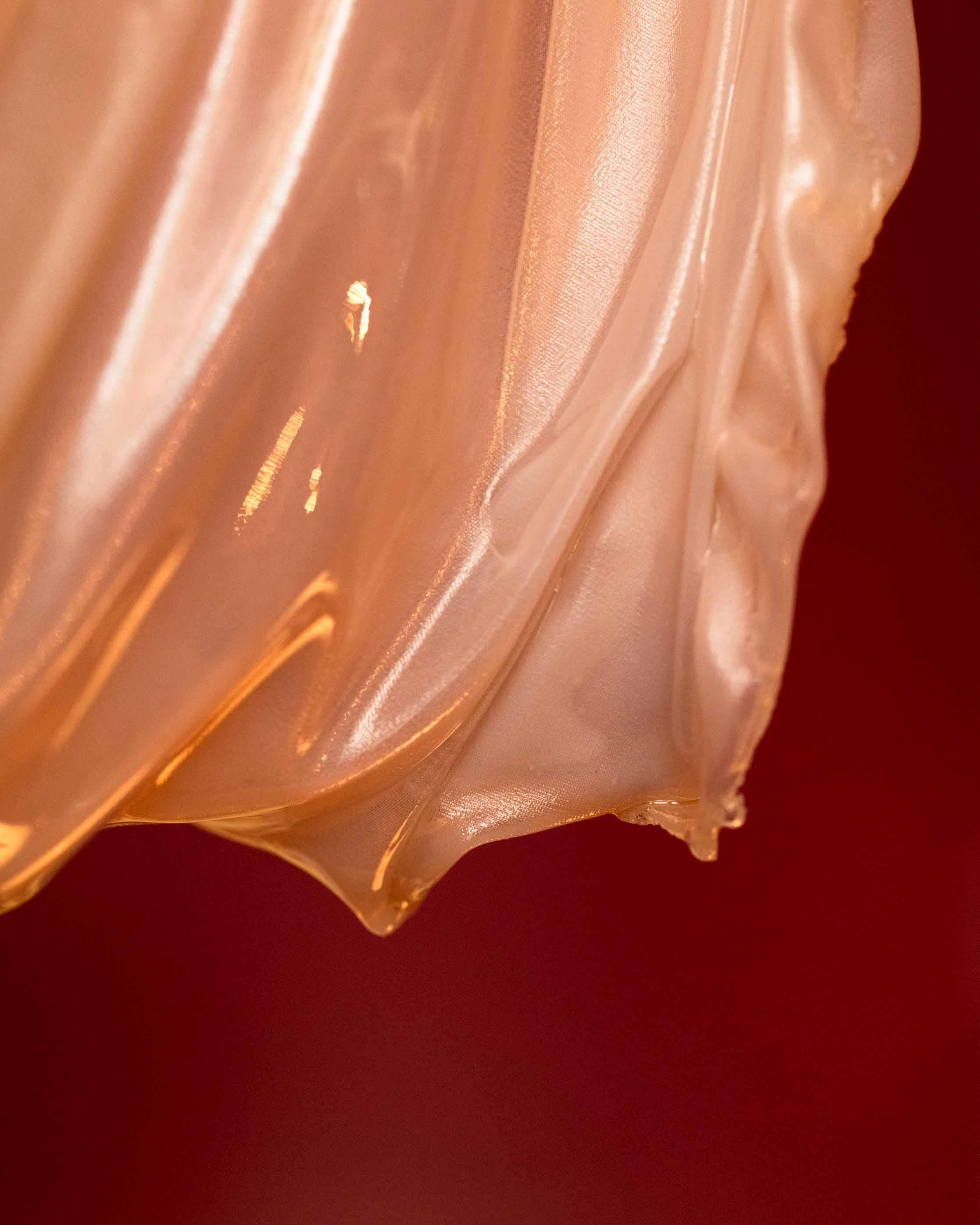 The Husk Light is a sculptural fixture made from transparent textile, hand-dyed with coffee and molded in resin. It casts a warm, natural glow and brings a soft, organic feel to any space. Inspired by husks and cocoons, it blends texture, light, and