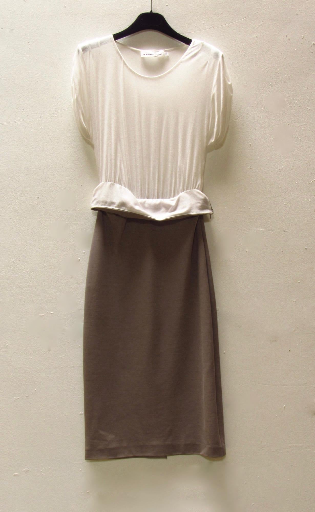 Two-tone dress by Hussein Chalayan. This dress has a lightweight white modal-blend top with a scoop neck and cuffed short sleeves. It is tucked into a body-hugging pencil skirt in a taupe rayon blend knit. The skirt sits below the knee and has a