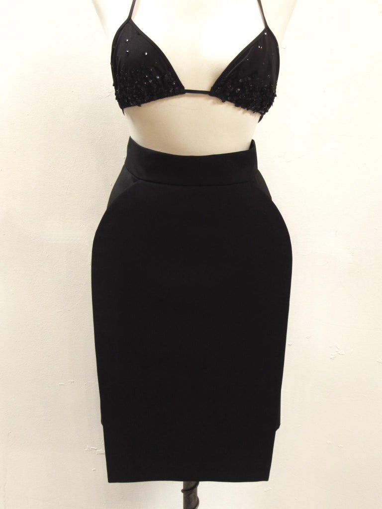 This is a classic black pencil skirt made edgy with a structured round front panel. Beautifully constructed of soft wool by vintage Hussein Chalayan. 