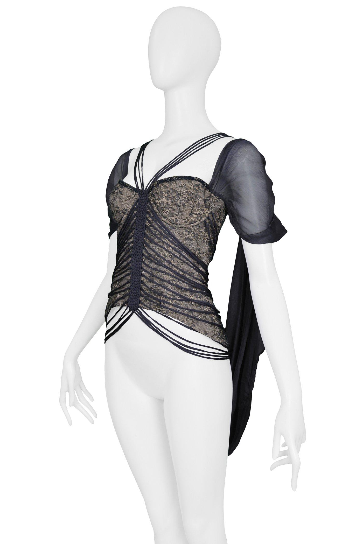 Resurrection is pleased to offer this vintage Hussein Chalayan grey chiffon and lace bustier top featuring several decorative bands and straps, braided centerpiece, center back zipper, overlay sleeves with nude lining.

Hussein Chalayan
Size