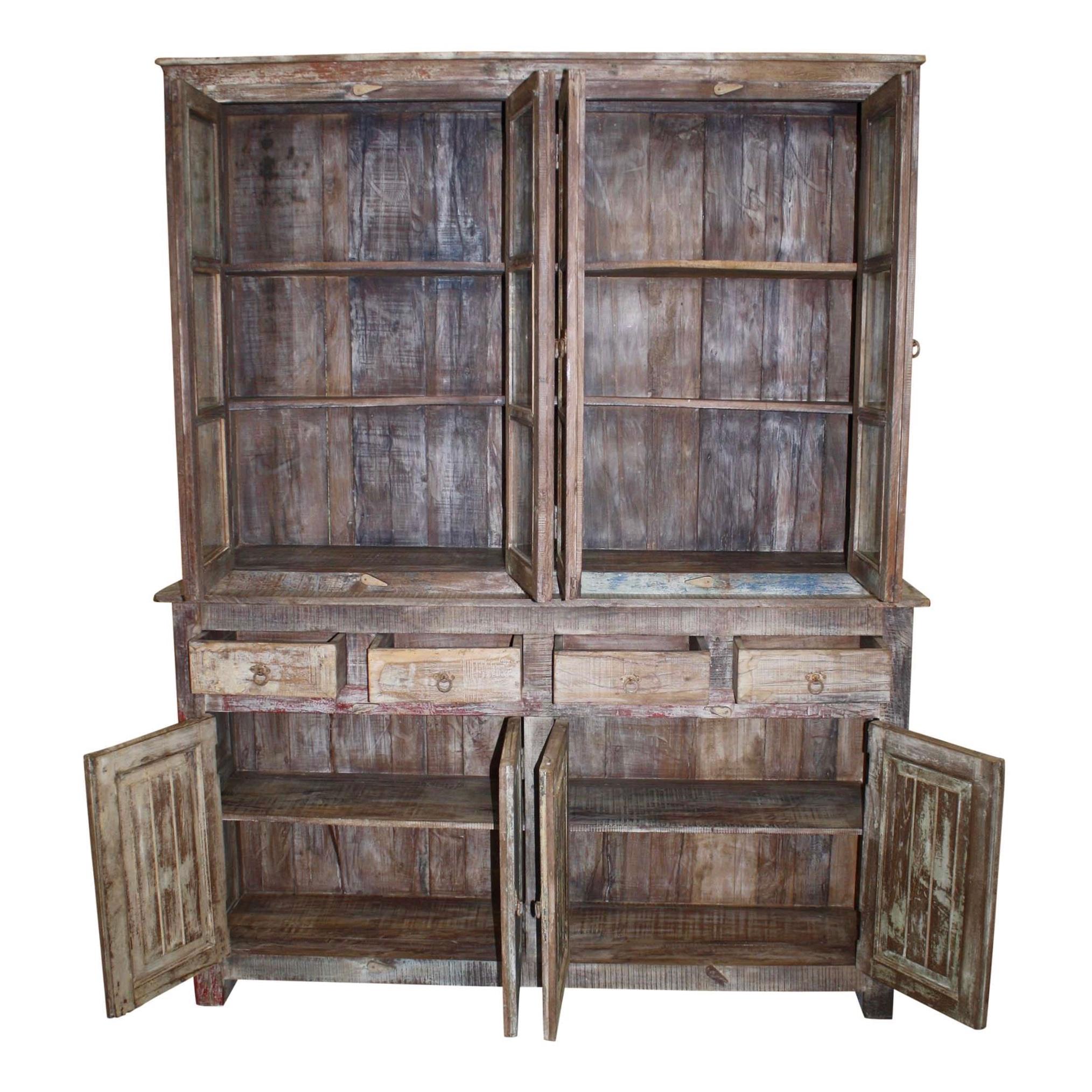 An exceptional, reproduction piece of solid wood construction and glass pane doors, this double-bodied, painted and distressed cabinet is suitable as a hutch, bookcase, or display cabinet. The upper portion has four doors with three glass panes in