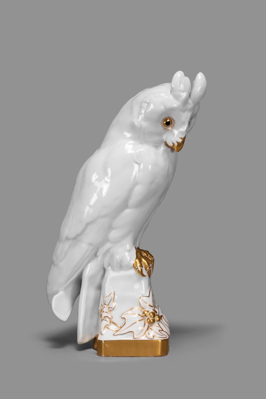 The 24 carat gilded owl was created by Professor Fritz Klee around 1920 for Hutschenreuther Porcelain. This beautifully crafted piece is unusual in that surrounding the base are opened decorative poinsettia flowers. There are two very old stamps on