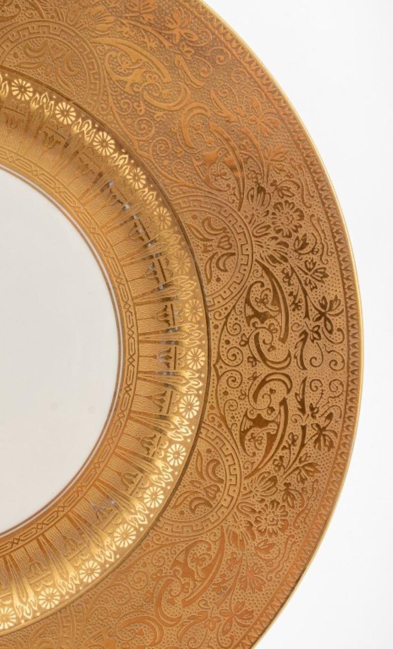 Hutschenreuther German porcelain entree plates, the rims with raised gold embossed Art Nouveau / Jugendstil manner scrolling floral designs, each with 