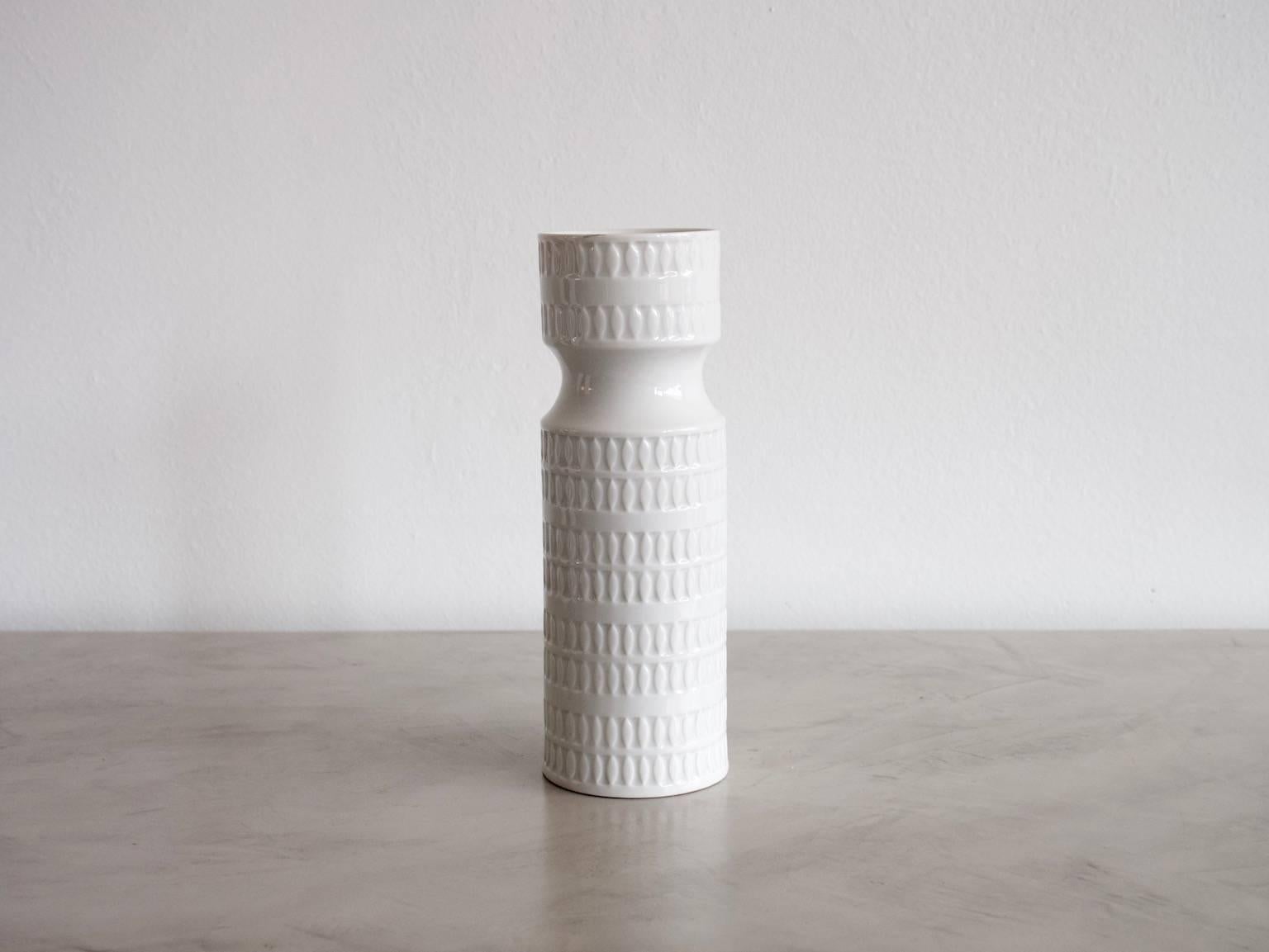 Tall tower-like white porcelain vase with a relief finish. Manufactured and marked on the bottom by Hutschenreuther, circa 1970s.