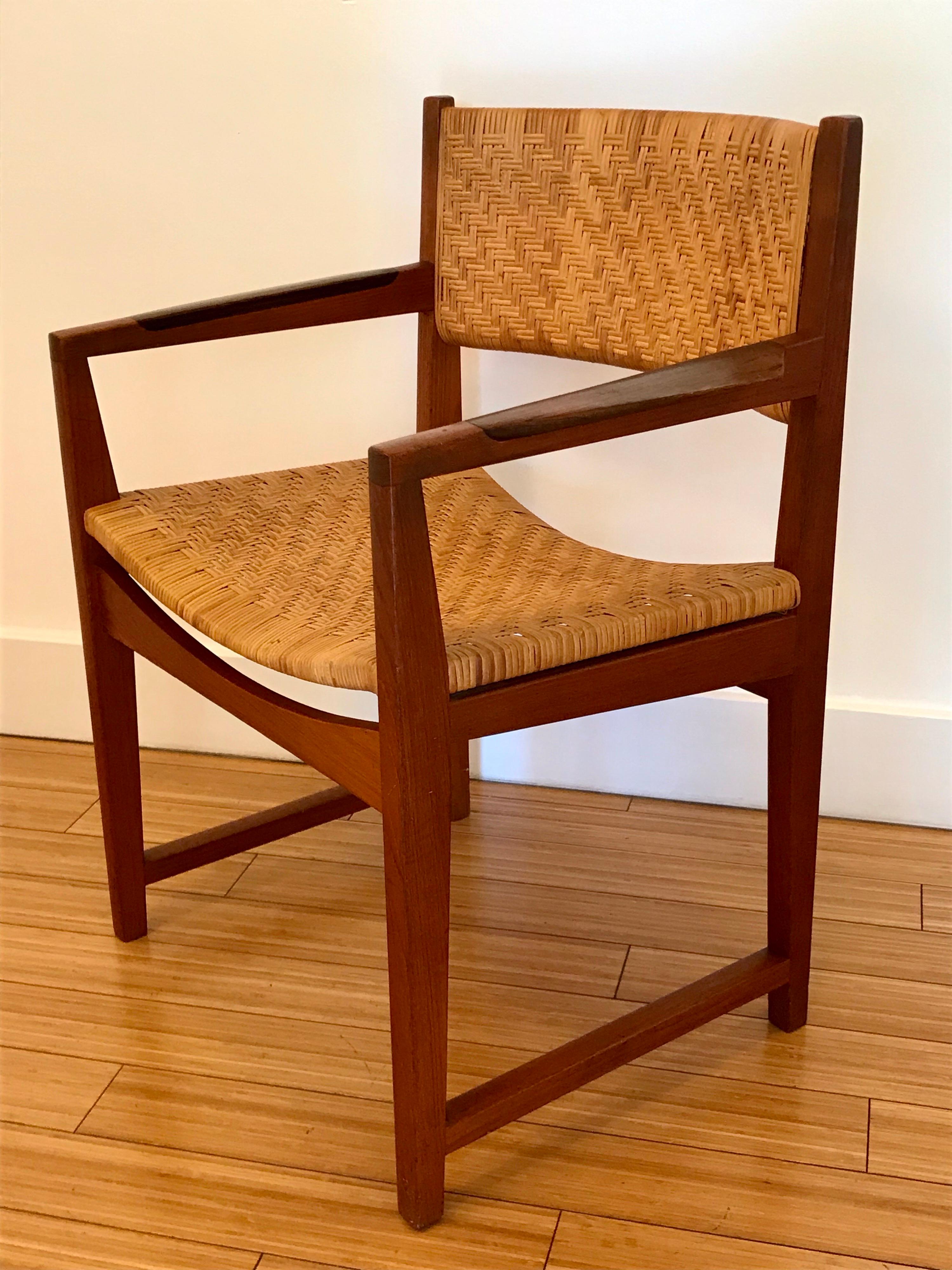 A handsome Danish modern design
solid teak wood construction 
rosewood armrest detail 
cane seat and back
comfy and stout
great for a desk or add to a dining set or use as an accent anywhere.
  