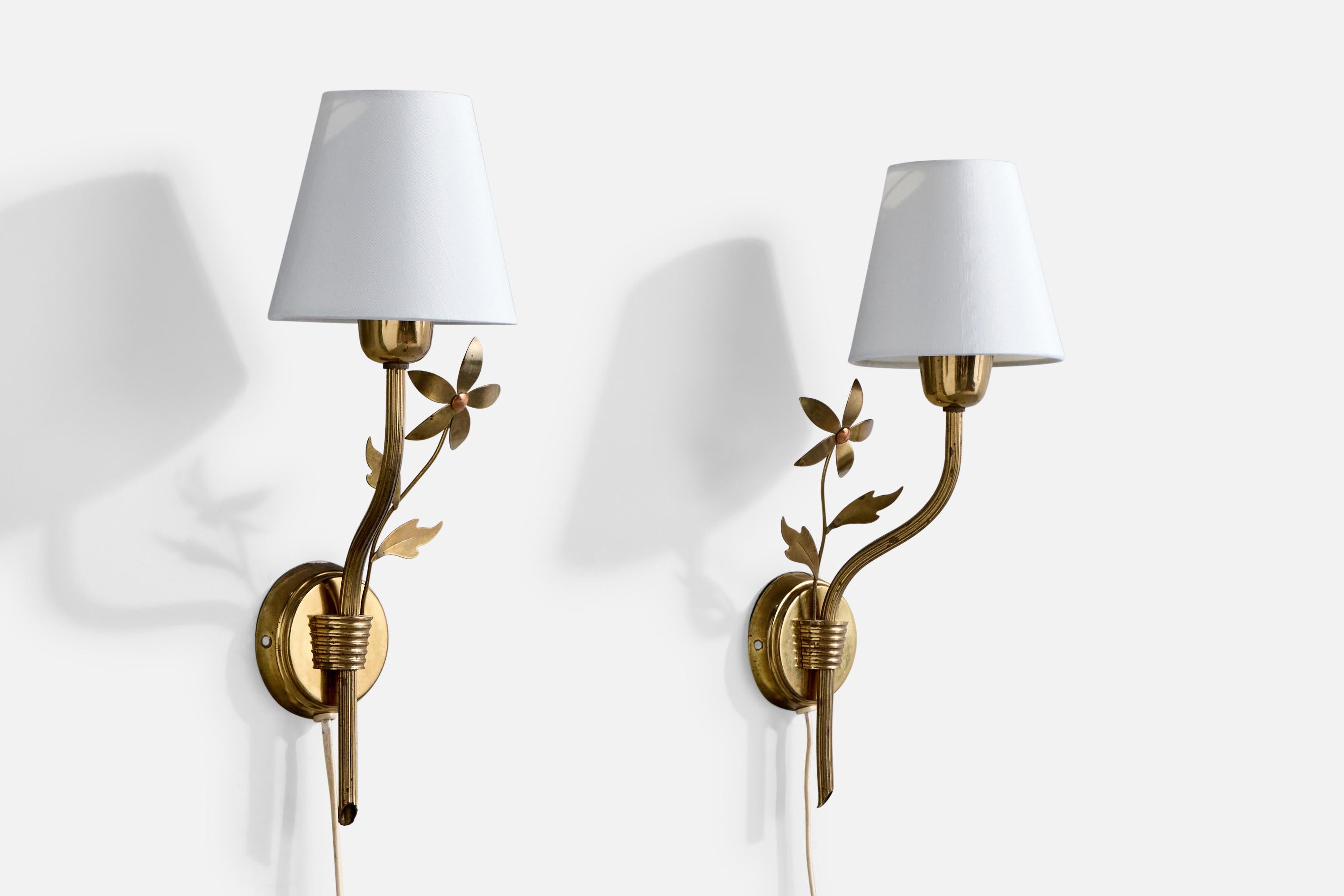 A pair of brass and fabric wall lights produced by Høvik Verk, Norways, c. 1950s.

One of the brass sockets presents with a vertical crack.

Brand new fabric shades.

Overall Dimensions (Inches): 15.25” H x 5.8” W x 6” D

Back Plate Dimensions