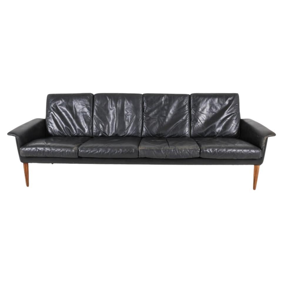 It doesn't get much better than aged leather and rosewood! This is the sofa designed by H. W. Klein for Bramin (NA Jørgensens Møbelfabrik), Denmark, in 1966. The four seat model is rare.
Soft, high-quality black leather. Solid Brazilian rosewood