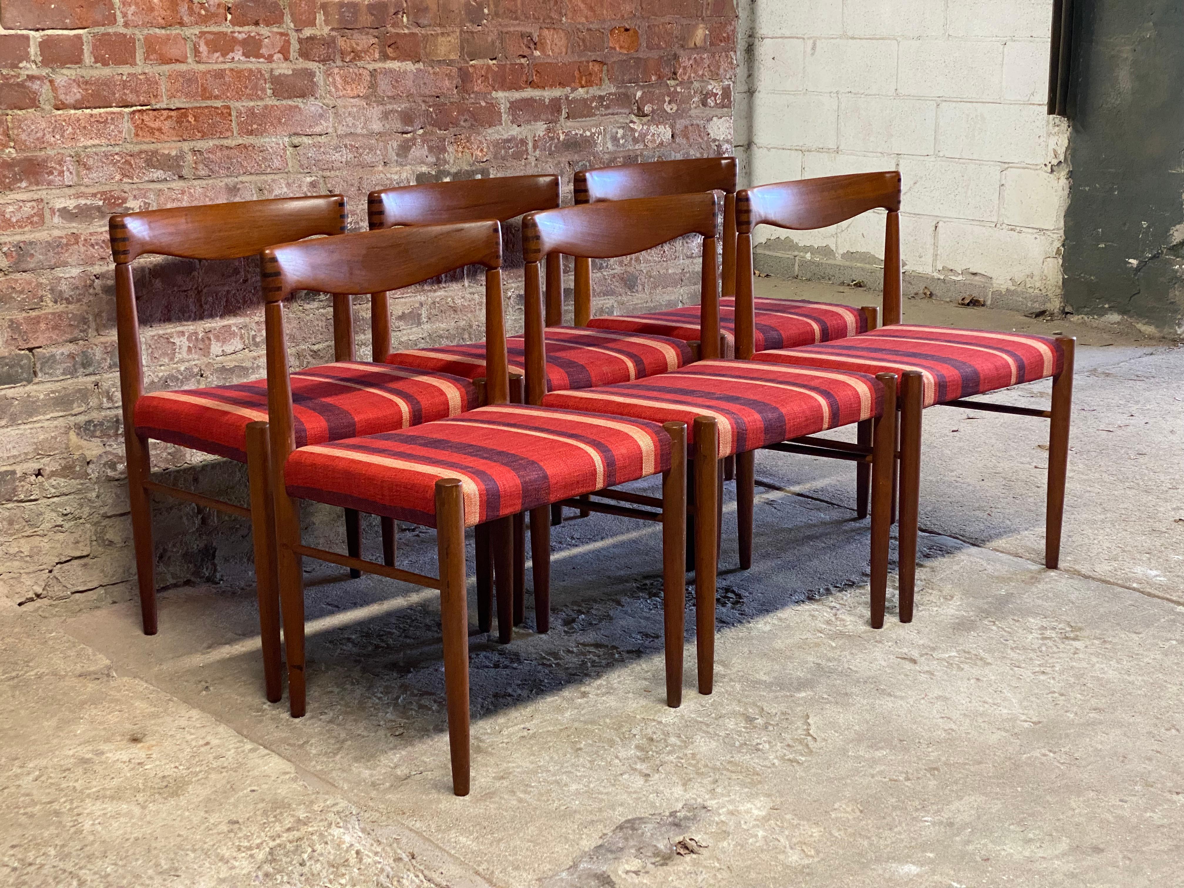Structurally sound and sturdy solid teak set of six dining chairs by H.W. Klein for Bramin Mobler. Featuring a contoured back rest, tapered legs, dowel stretcher base, freshly upholstered seats and the signature finger joint dovetail detail on the