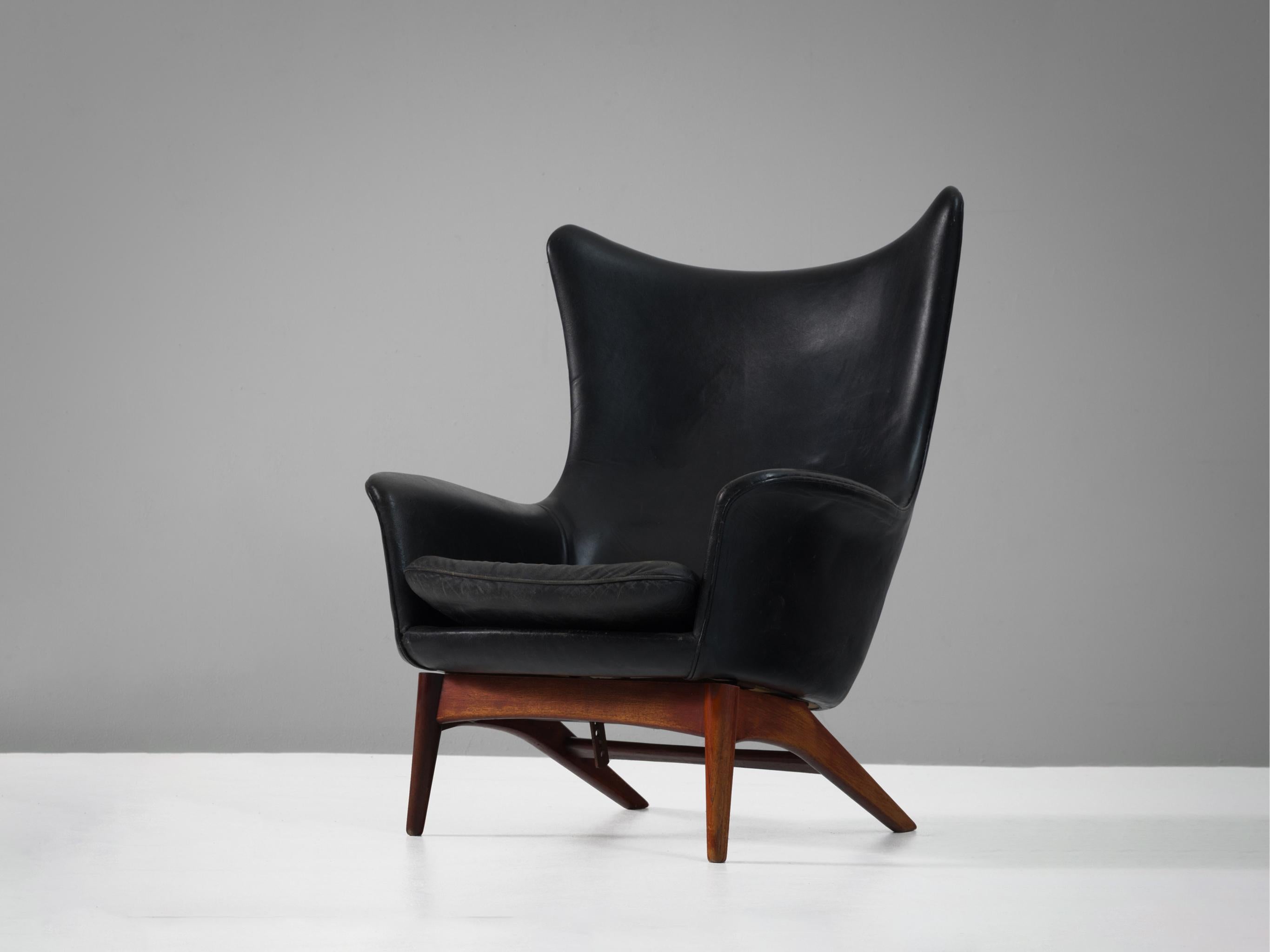 H.W. Klein for Bramin wingback chair, teak, leather, Denmark, 1950s. 

Sculptural lounge chair by Henry Walter Klein. This wingback chair is a great example of Scandinavian design and comfort. Beautiful organic formed seating, with solid wooden