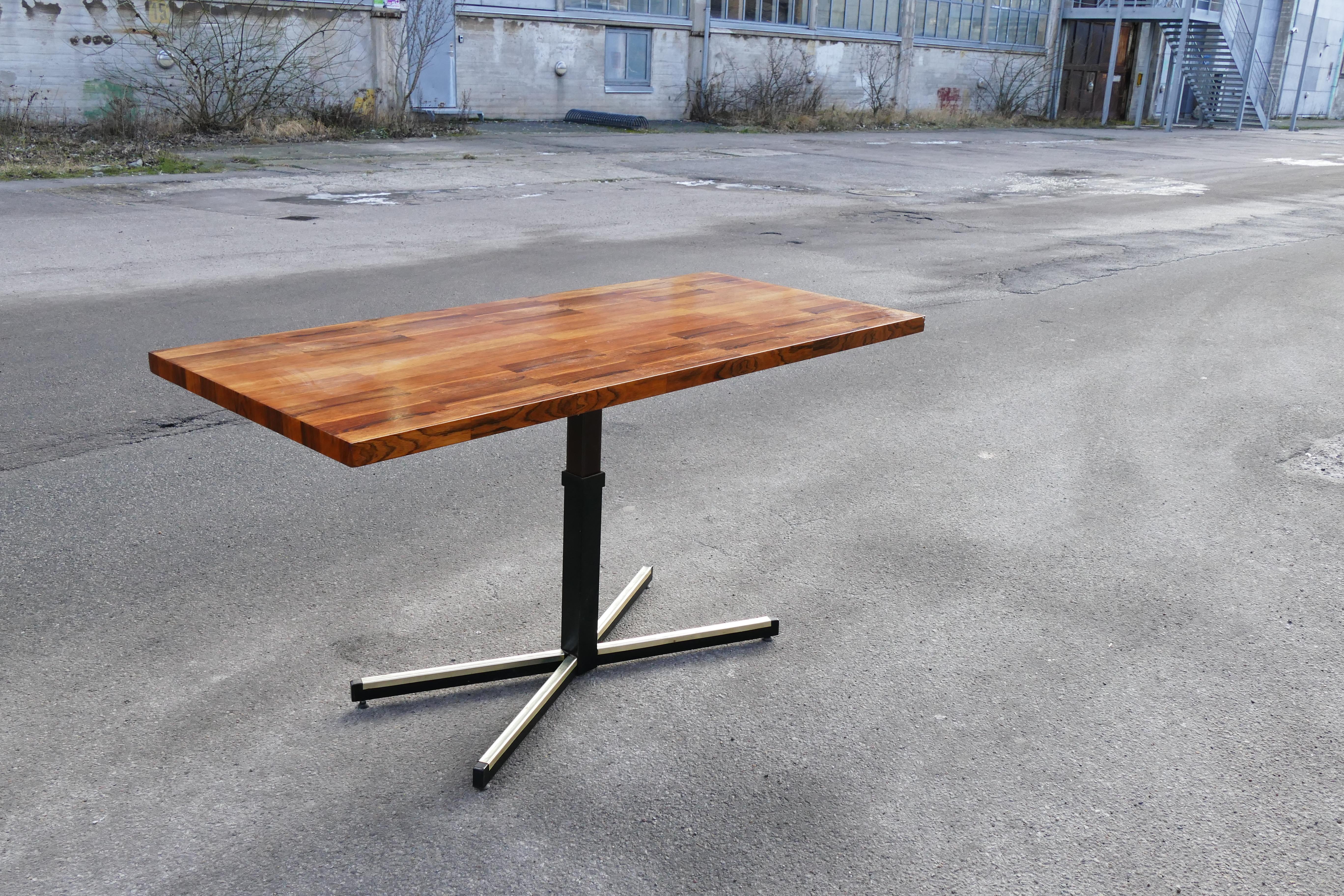 A unique coffee table that can be raised to a dinning or desk like height. Rosewood and beautiful details in this piece of modern history.