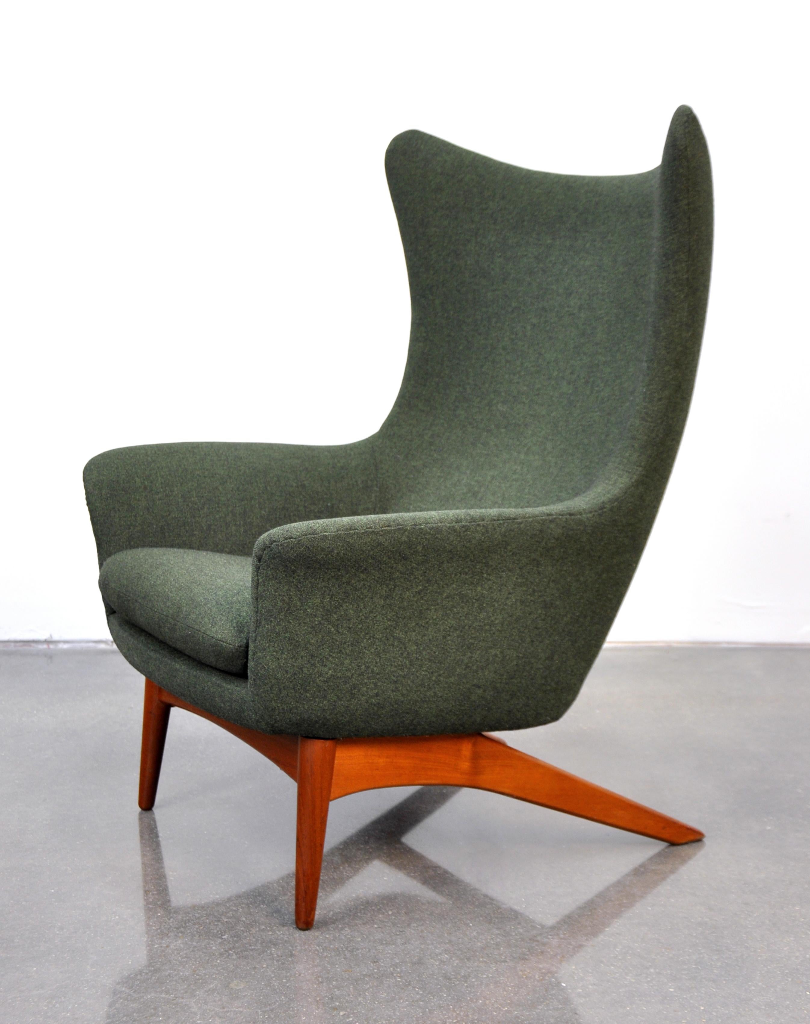 Vintage Danish midcentury teak reclining wingback rocker lounge chair, model 207, designed by Henry Walter Klein for Bramin Mobler (aka NA Jorgensens Mobelfabrik) in the early 1960s. The outstanding design of the armchair features sharp wings, a