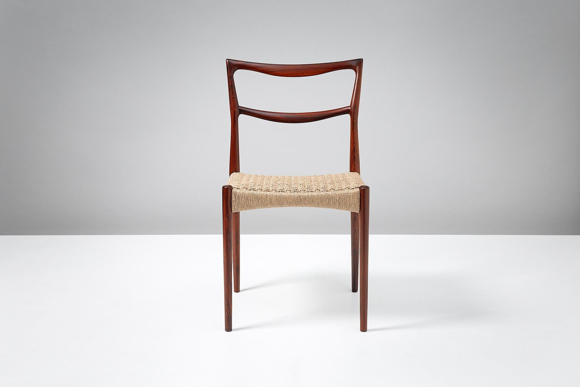 Rarely seen, sculptural side chair. Rosewood frame with woven papercord seat.