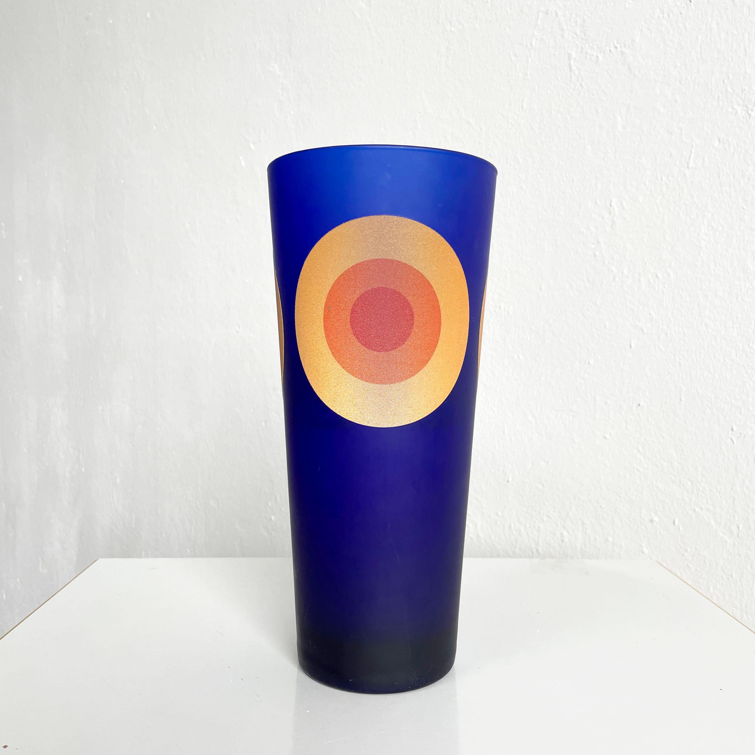 HWC vase manufactured in the 1990s in Italy by Sottsass Associati 

Design: Defne Koz

Cobalt blue glass in satin finish decorated with three circles in vibrant yellow, orange and red color

The vase is in very good condition, without any