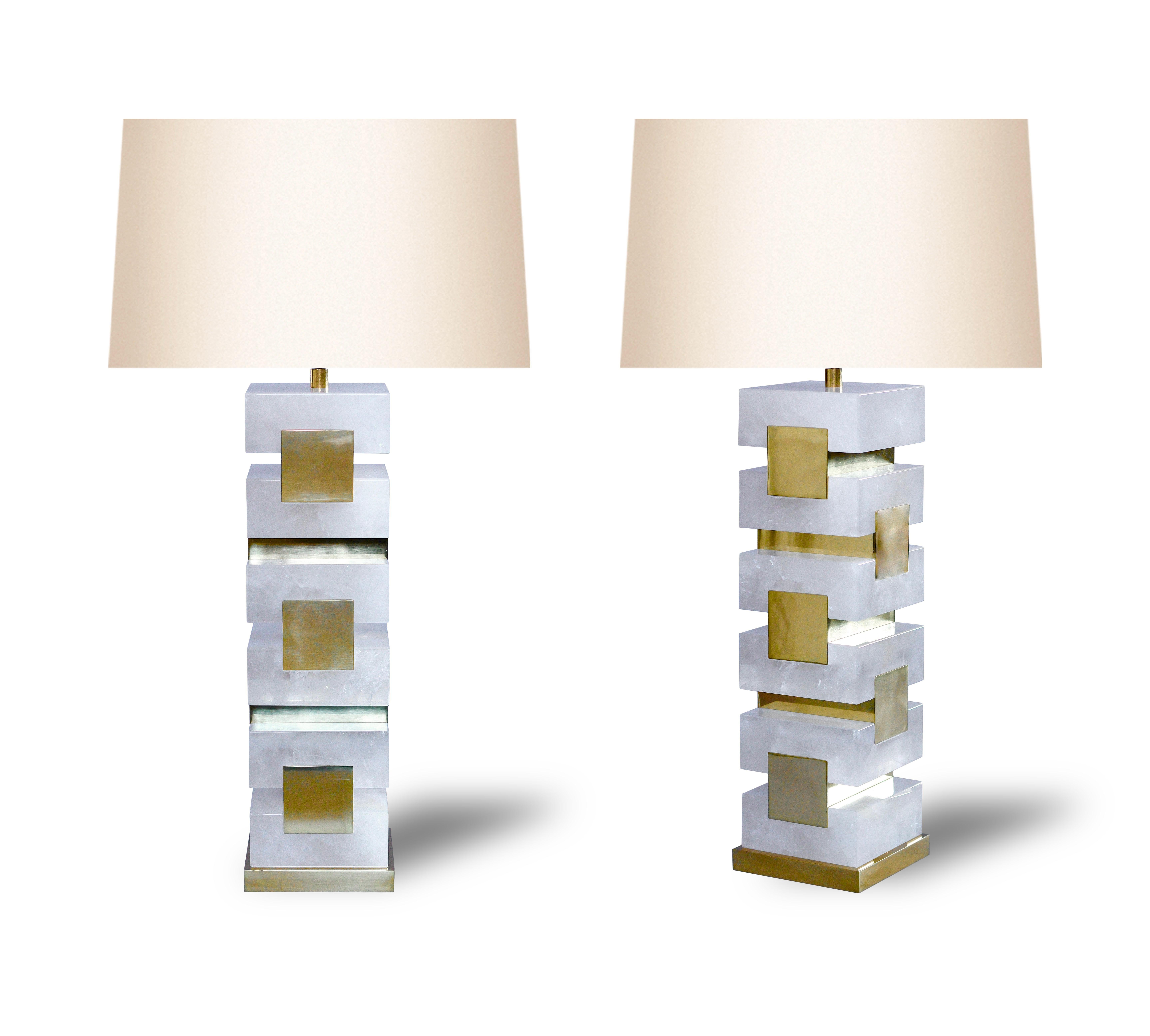 Pair of  rock crystal lamps with polish brass inserts decorations.

to the top of the rock crystal 15 inch.

Lamp shades are not included.

Created by Phoenix 

Custom metal finish upon request.