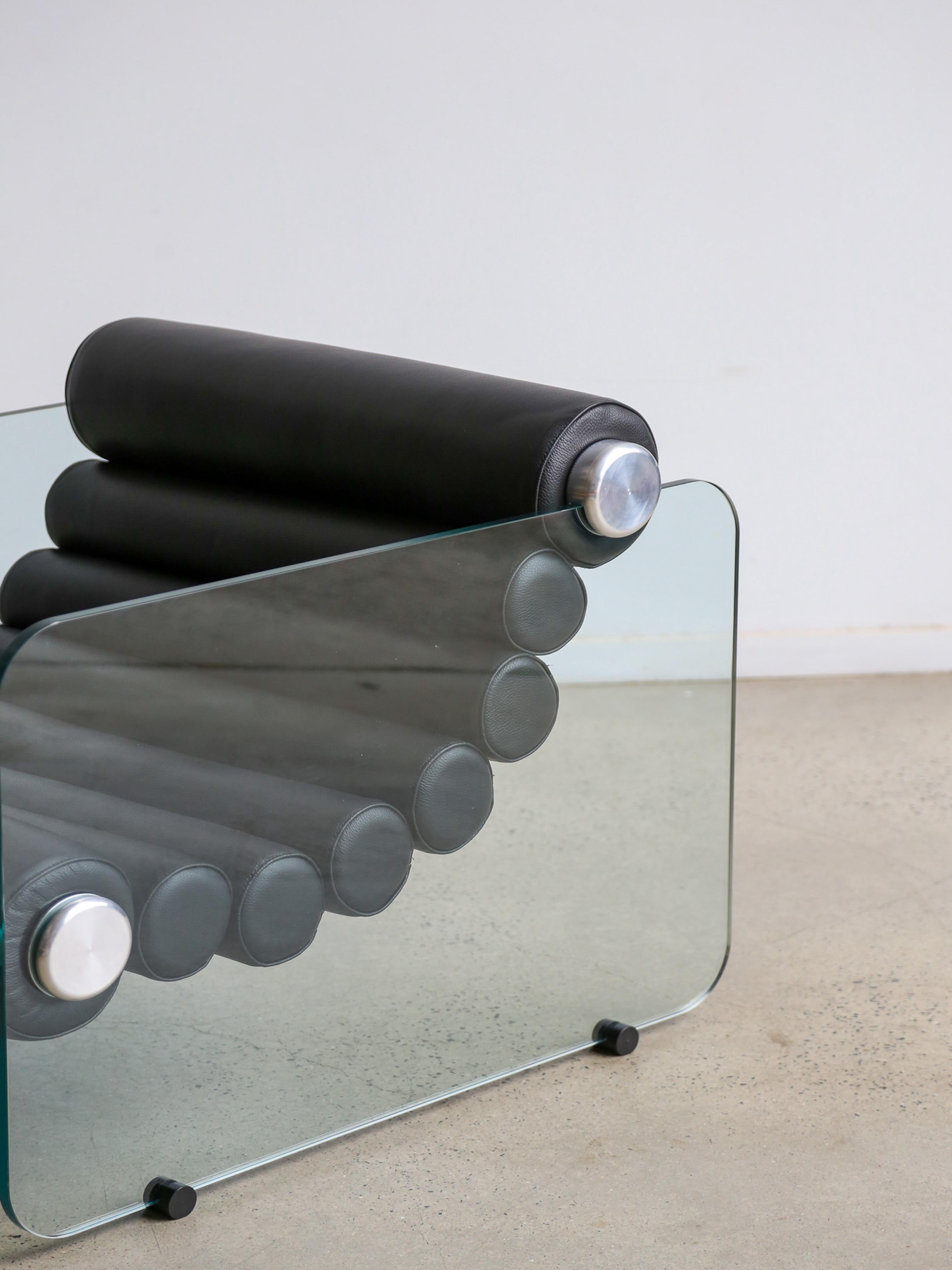 Italian space age design by Fabio Lenci, the Hyaline (pronounced as “Hay’Line) chairs are a prime example of Italian design of the time period. The thick leather rolls are interconnected in a flexible form and are fixed to the glass plates on the