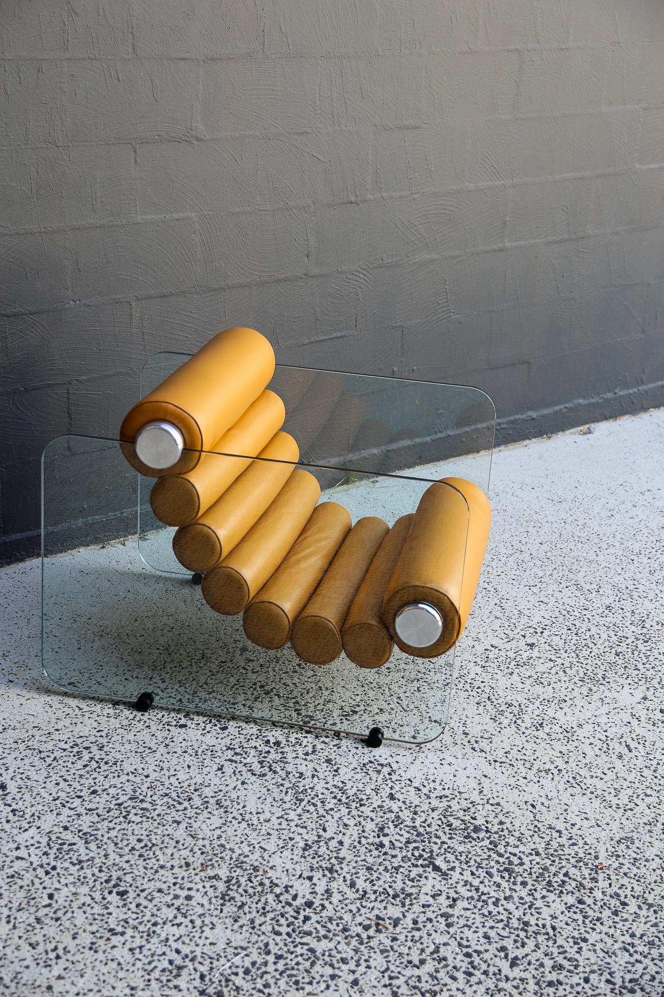 Set of two available
Italian space age design by Fabio Lenci, the Hyaline (pronounced as “Hay’Line) chairs are a prime example of Italian design of the time period. The thick leather rolls are interconnected in a flexible form and are fixed to the