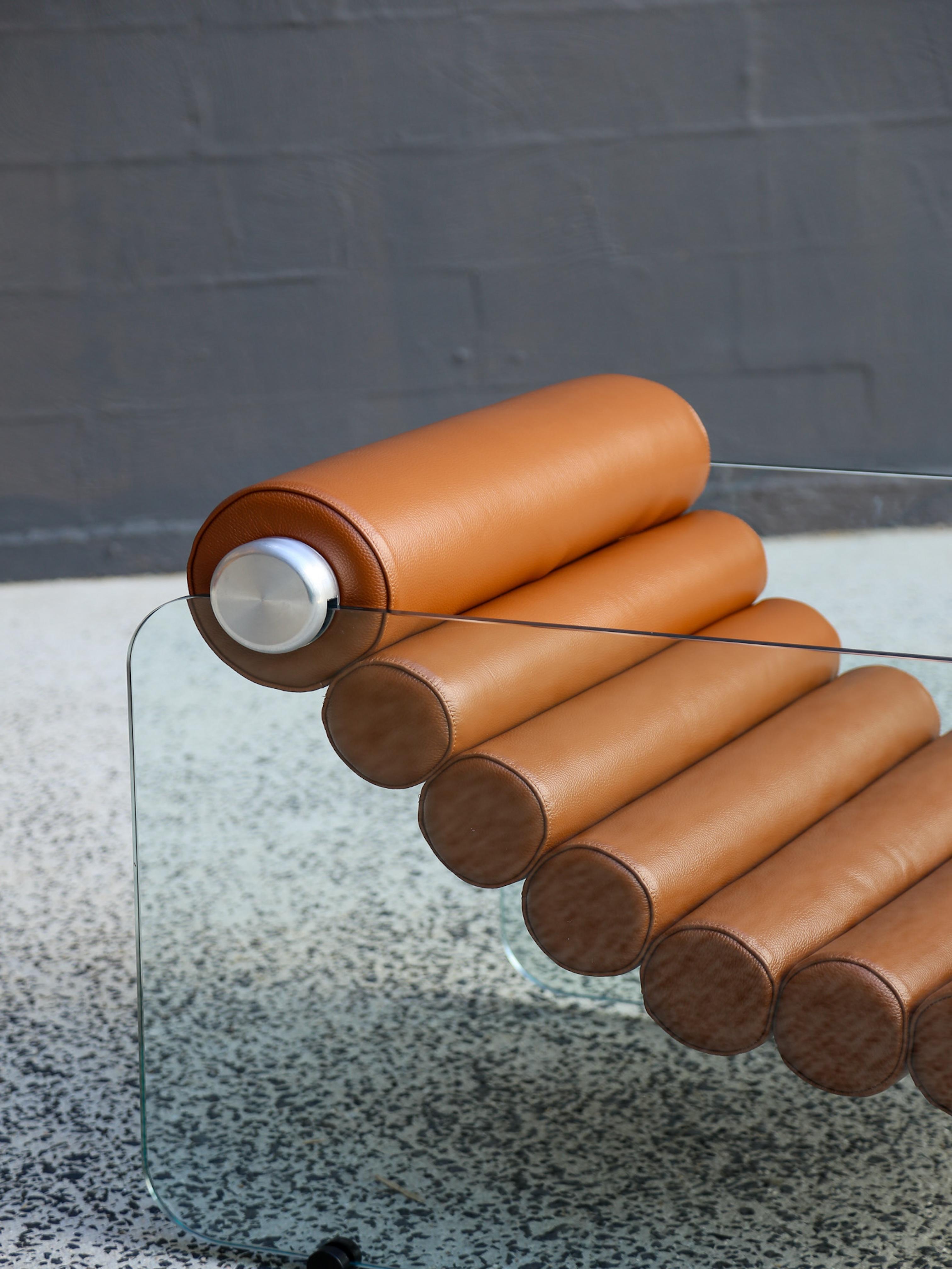 Set of two available
Italian space age design by Fabio Lenci, the Hyaline (pronounced as “Hay’Line) chairs are a prime example of Italian design of the time period. The thick leather rolls are interconnected in a flexible form and are fixed to the