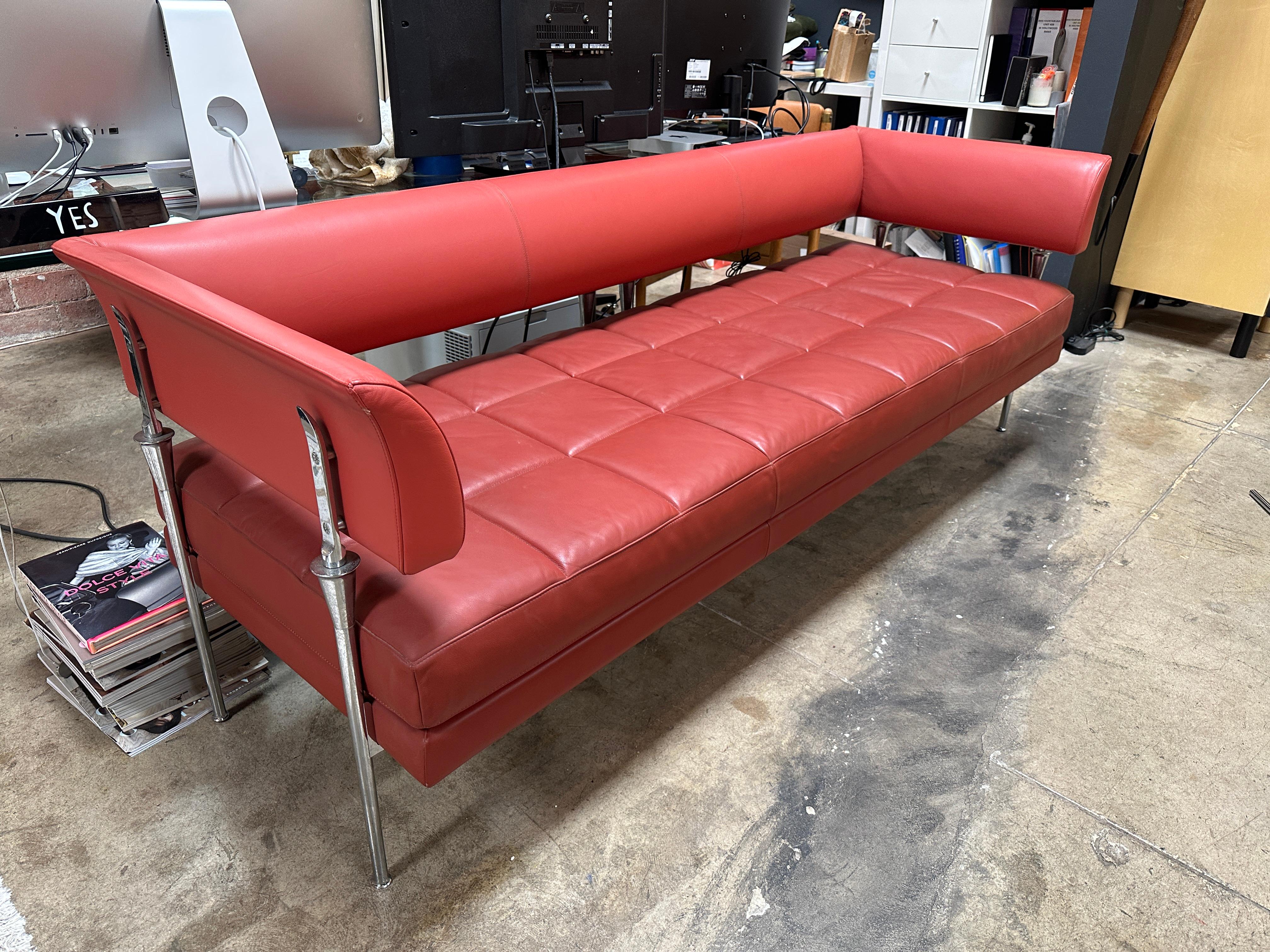 The Hydra Castor sofa is a piece of furniture designed by Luca Scacchetti for Poltrona Frau, an Italian furniture company. It features a striking combination of red leather and chrome, with a sleek, modern design that reflects the aesthetic of the