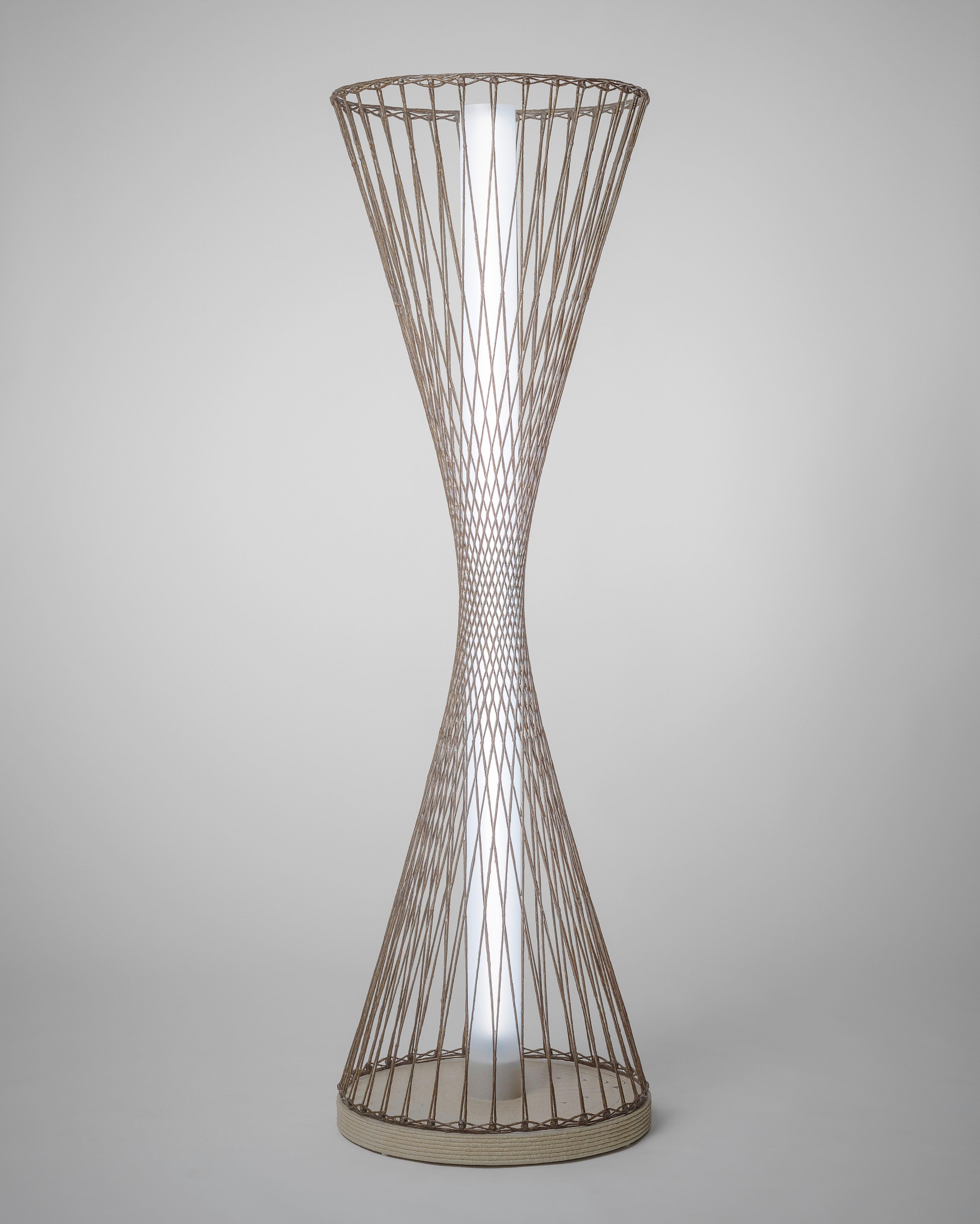 Hyperboloid Lamp by Philipp Aduatz
Limited Edition of 8
Dimensions: D 58 x H 188 cm
Materials: Flax fibers, biobased epoxy resin, acrylic, aluminum, LED-illumination, 3D-printed concrete base.

All our lamps can be wired according to each country.