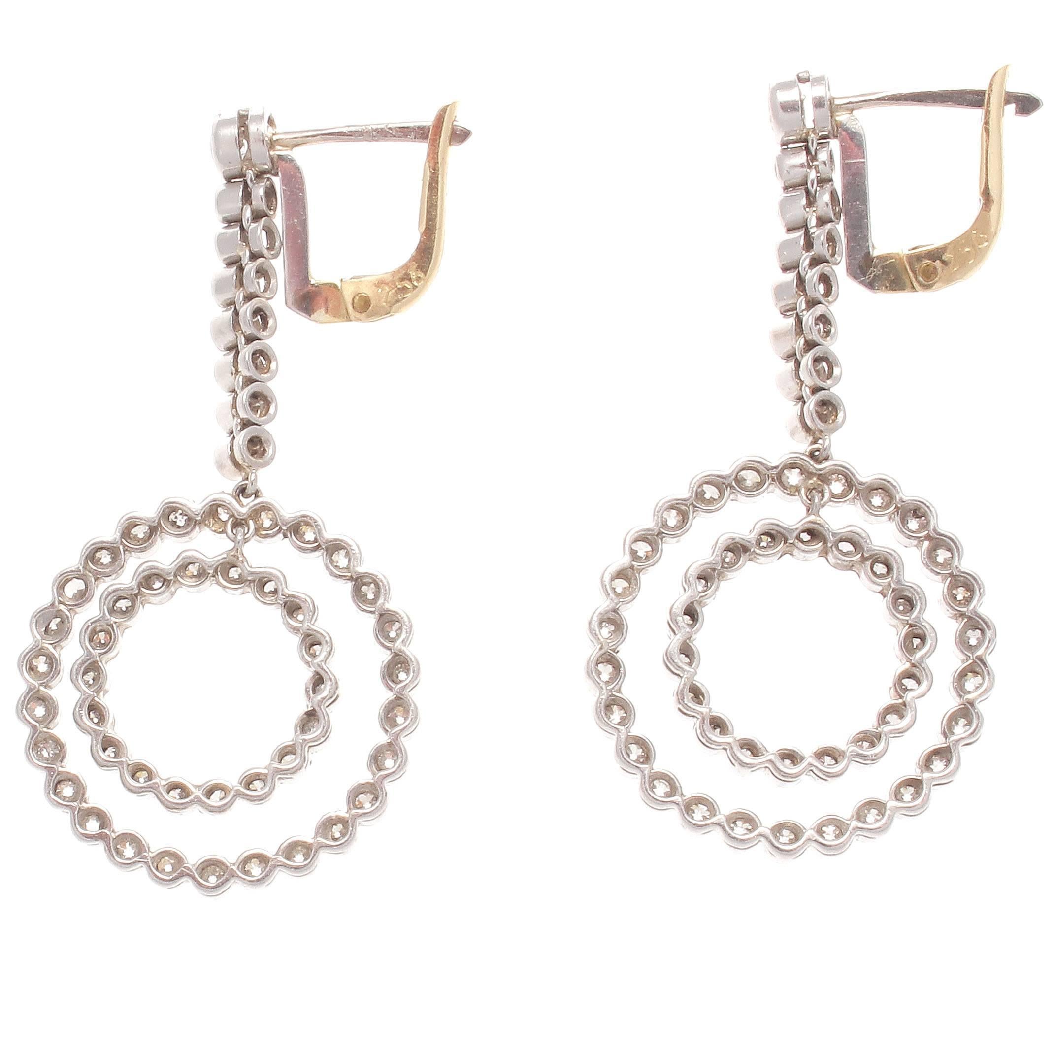 The double circle diamond earrings are in the style of one of the most creative eras of jewelry, Art Deco. Designed with 104 diamonds weighing approximately 2 carats that are H-I color, VS clarity. Hand crafted in platinum.