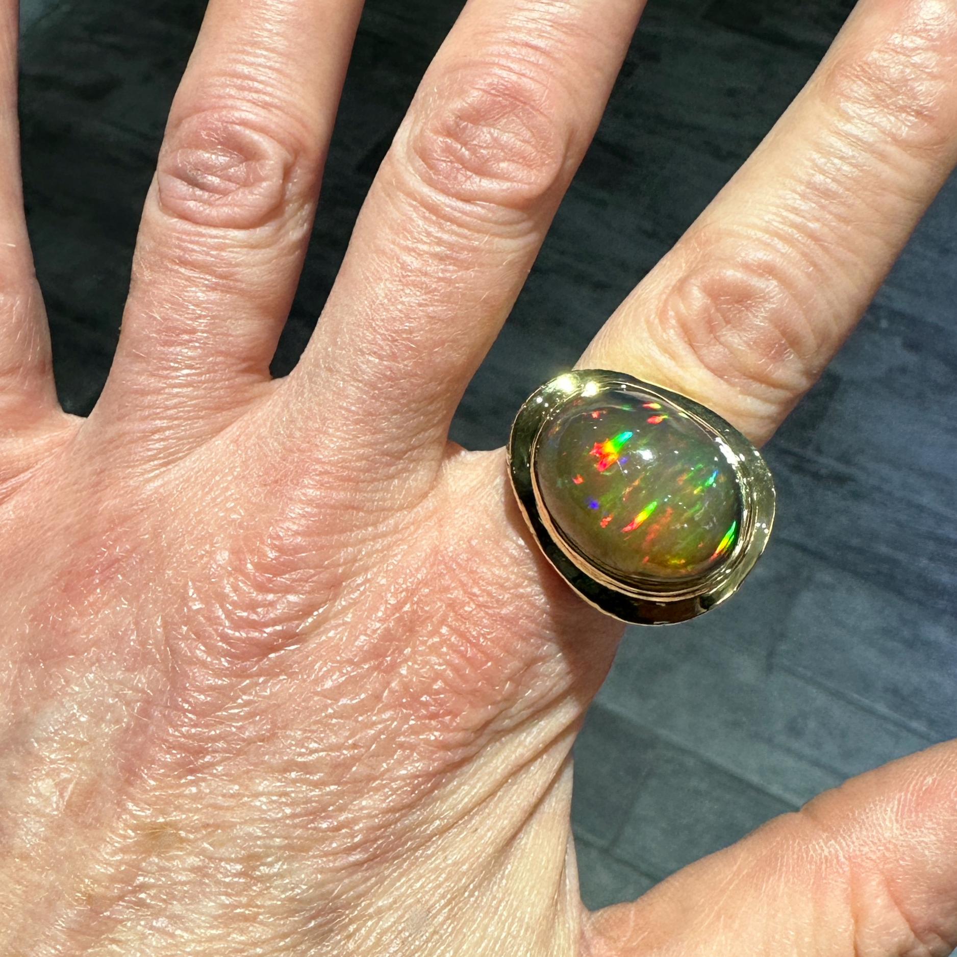 This new, one-of-a-kind ring by Eytan Brandes features a spectacular, high-domed Ethiopian opal with moody brown body color and a veritable firestorm of internal colors -- orangy-red, green and yellow predominate but there's even an overall
