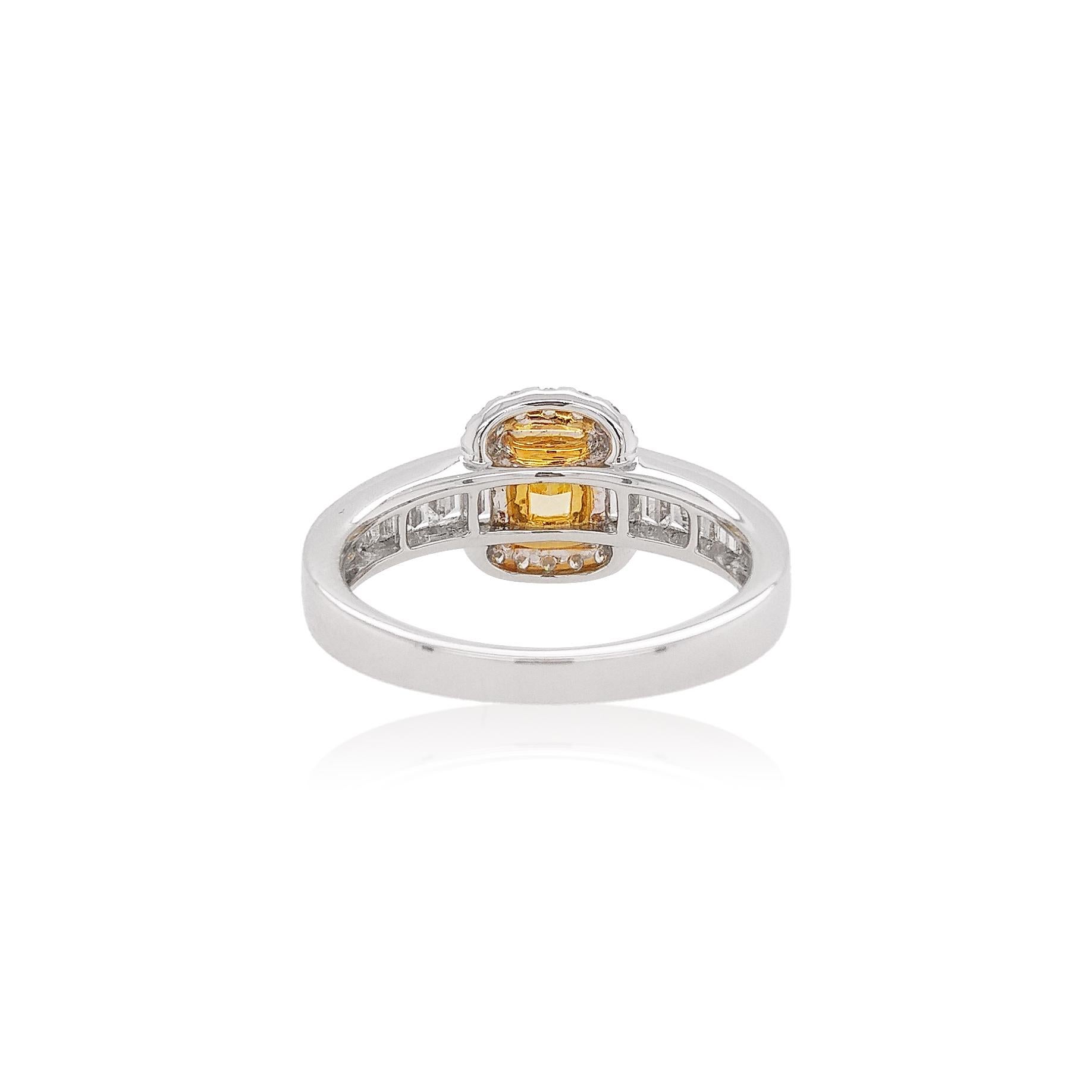 This delicate ring features a lustrous Fancy Intense Yellow Diamond at the forefront of its design. The spectacular hues of the Yellow Diamond are perfectly accentuated by the Platinum and 18 Karat Yellow Gold setting, and elegant Baguette White