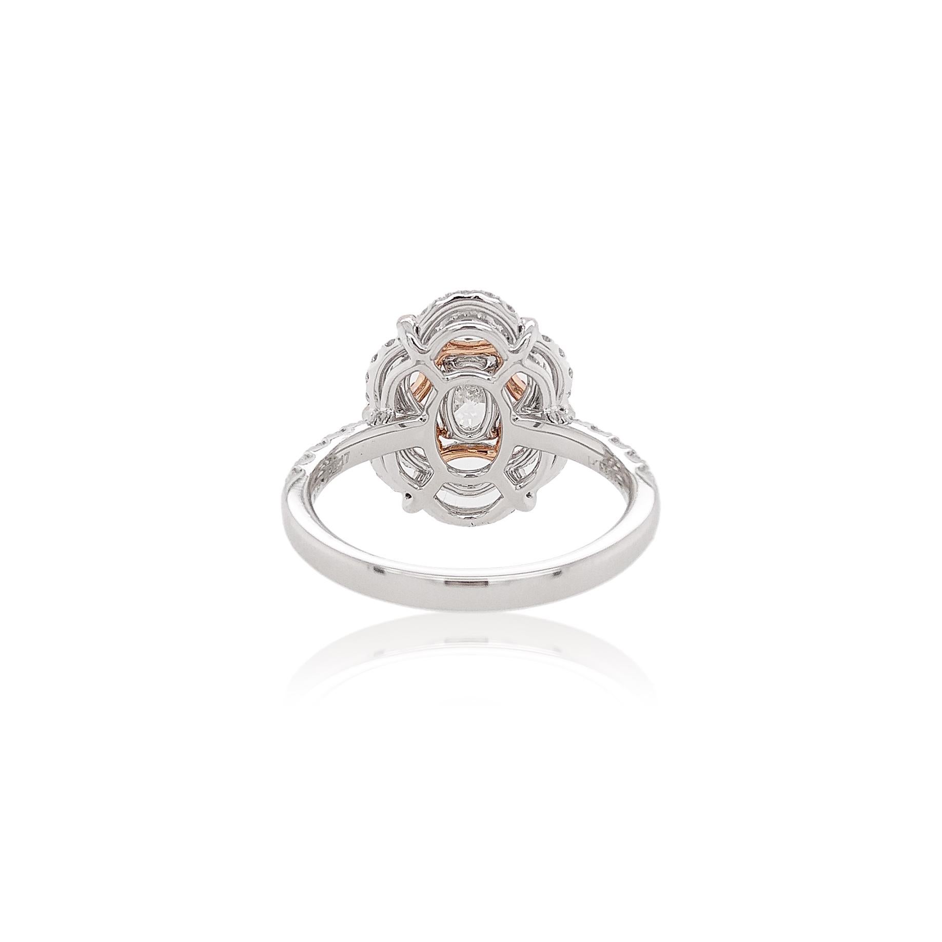 This elegant Platinum ring features a spectacular, GIA certified Oval White Diamond set amongst a floral Argyle Pink Diamonds motif. Dazzling and playful, this spectacular cocktail ring will add a touch of elegance to any outfit. Handcrafted by our