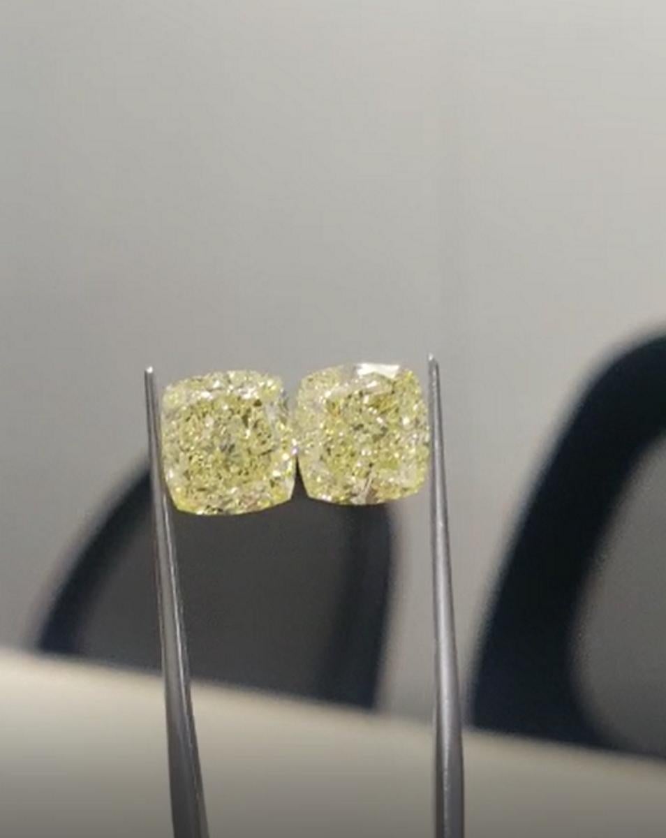 An exquisite pair of internally flawless GIA certified 2.48 carat fancy intense yellow cushion cut diamond studs
