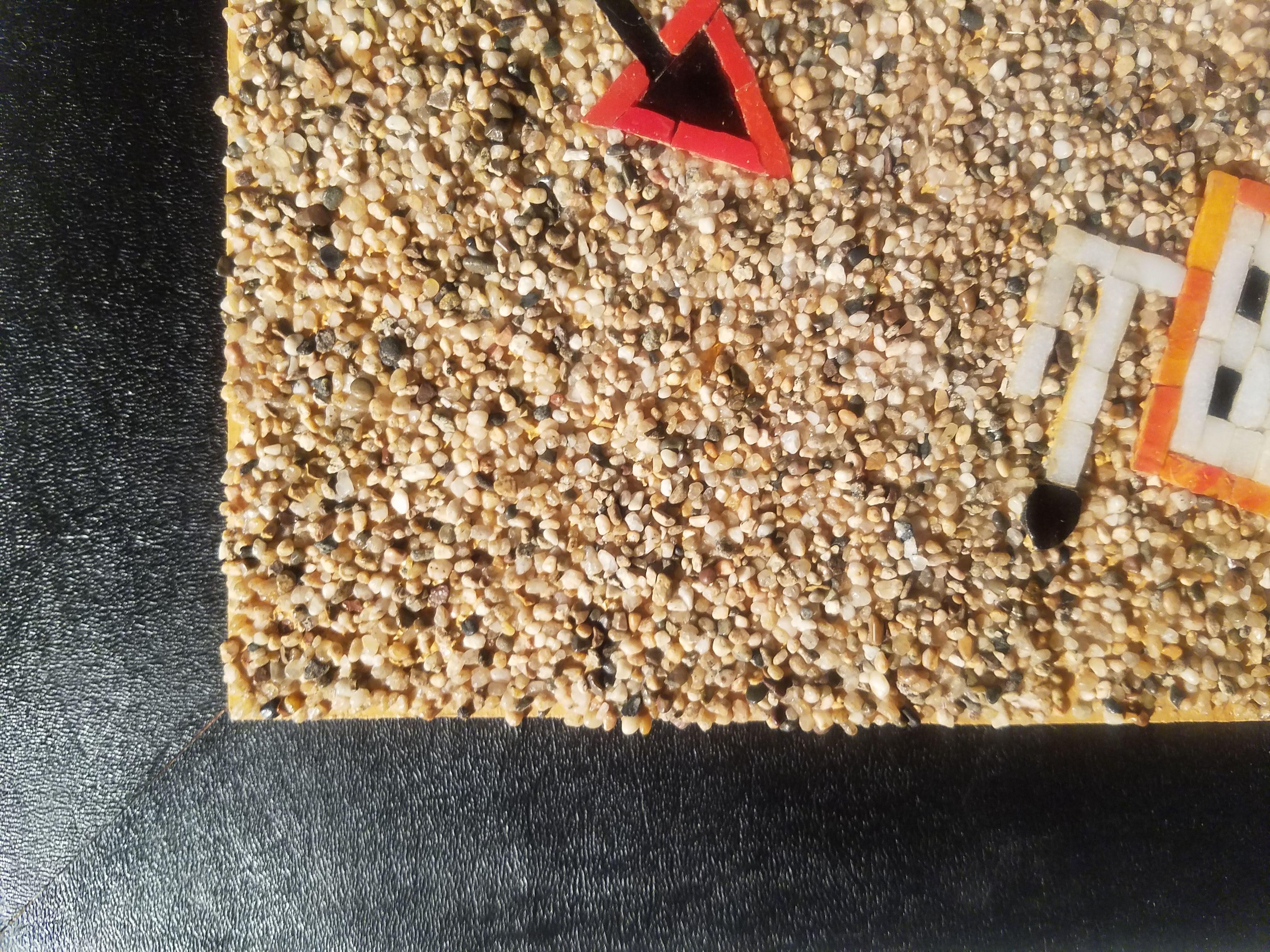 This powerful mid-century mosaic panel presents a Navajo-style Thunderbird figure rendered in richly textured mixed media, combining ceramic tile, colored glass, and sand. The composition is bold and highly graphic, centering on the Thunderbird with