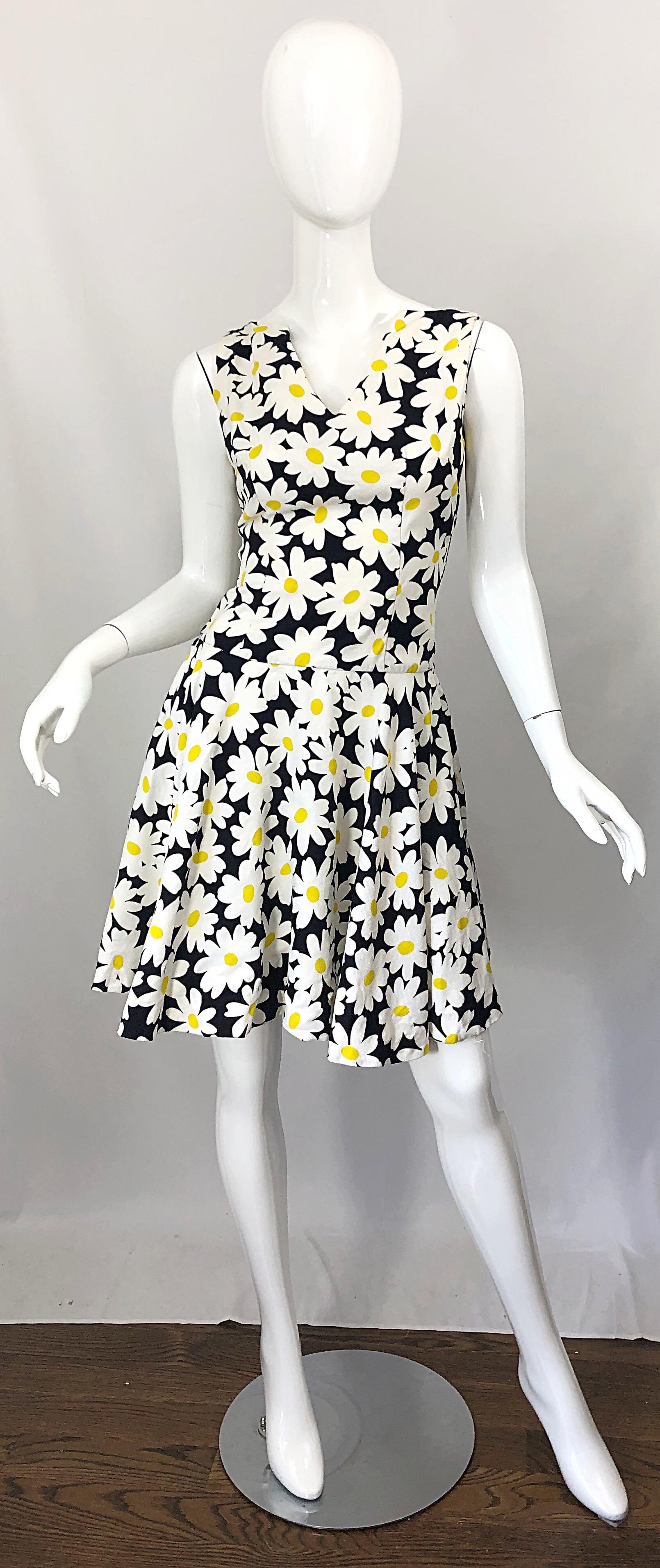 Chic 1960s I. MAGNIN black, white and yellow mod daisy flower print cotton pique A-Line dress! Features a
V-neck bodice with thin straps at each shoulder. Full metal zipper up the back with hook-and-eye closure. Soft comfortable pique cotton is