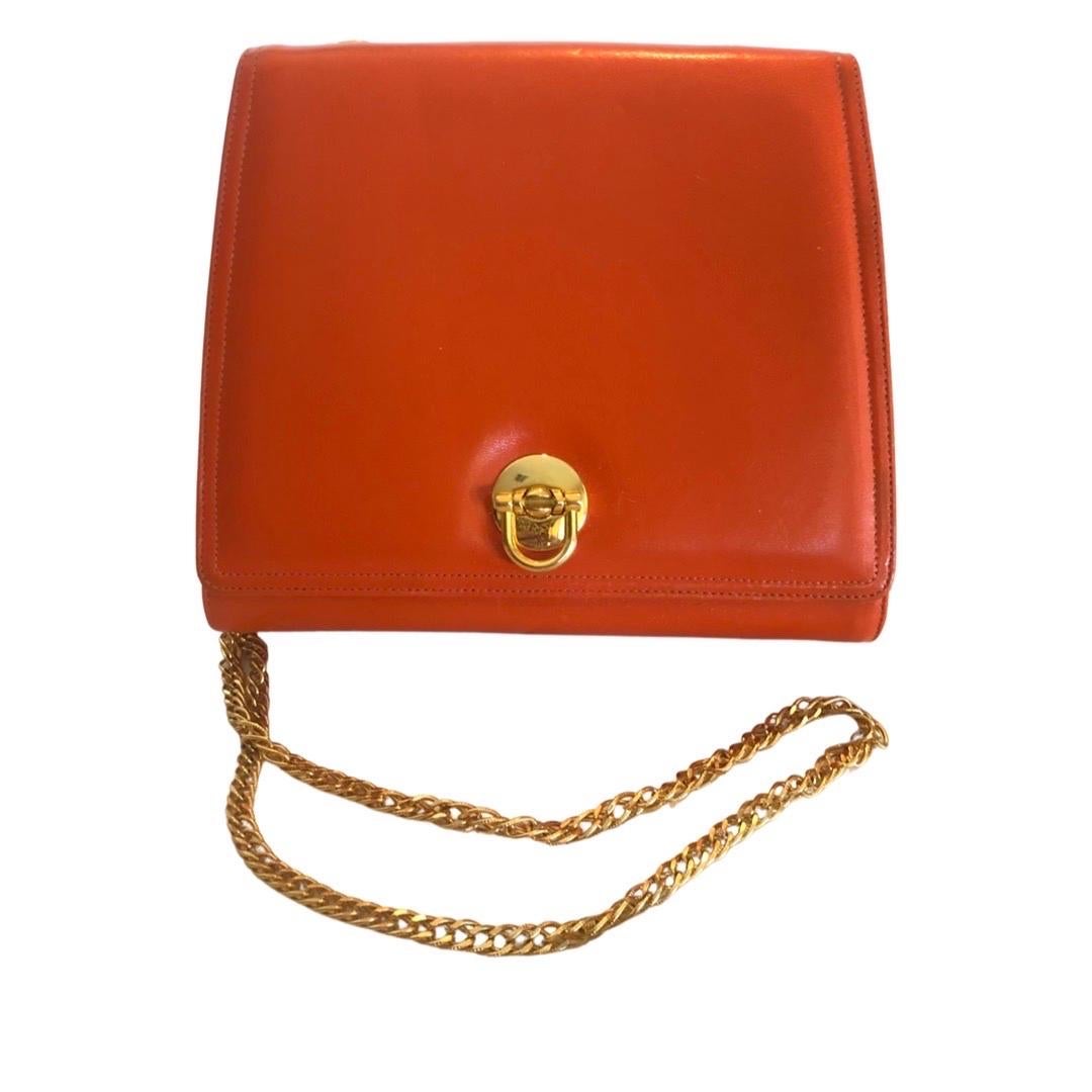 A very chic modern handbag from I Magnin Design Studio. Purchased in 1990s at I Magnin Beverly Hills. Color is a beautiful tangerine orange (in some pics it looks darker, butvis a nice bright orange. Original gold chain looks brand new. Gold closure