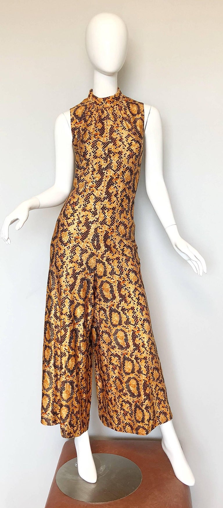 Sexy 70s I MAGNIN snakeskin animal print high neck palazzo leg vintage disco jumpsuit! Features a flattering high neck, with ties at back neck that can either be looped to hang, or into a bow. Fitted bodice, forgiving and flattering wide legs.