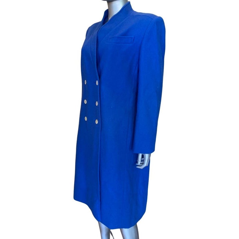 This coat looks so modern for a vintage 1970s coat. In beautiful original condition. Has a very modern shaped cardigan style collar. Strong but not big modern shoulder. Lined in a blue irridescent nylon lining. No fabric or size tag. See flat