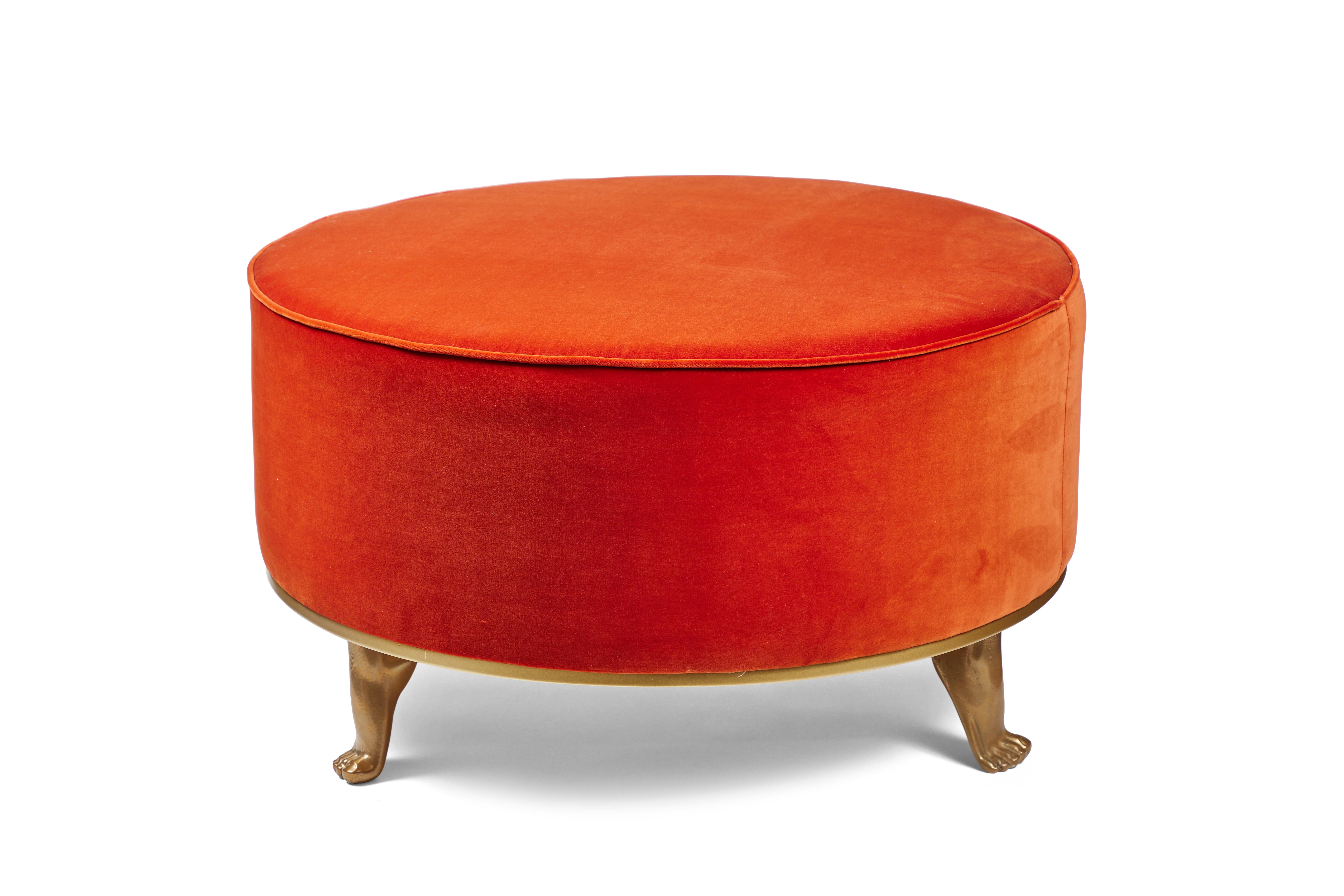 Playful and chic ottoman from the Modern Envy line by On Madison. Cast resin feet finished in your choice of metallic gold or silver elevate a round ottoman which can be finished in your choice of fabric. 6-8 weeks production time.