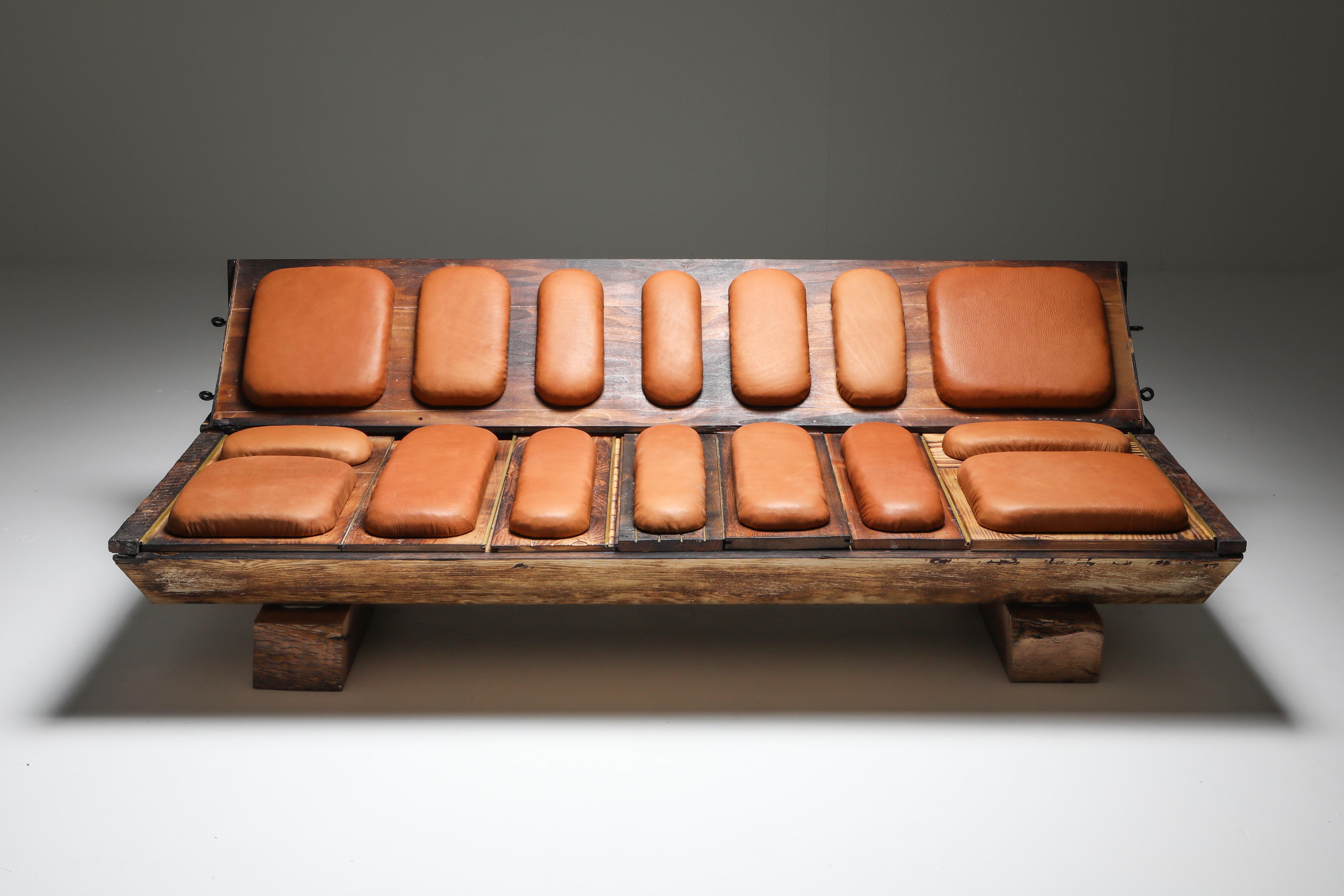 Assemblage functional art bench or sofa made from sections of a wooden ceiling installed in a bank by Christophe Gevers in the 1970s, burn-treated by Lionel Jadot, leather shapes are used for the cushions and solid wood used for the legs.