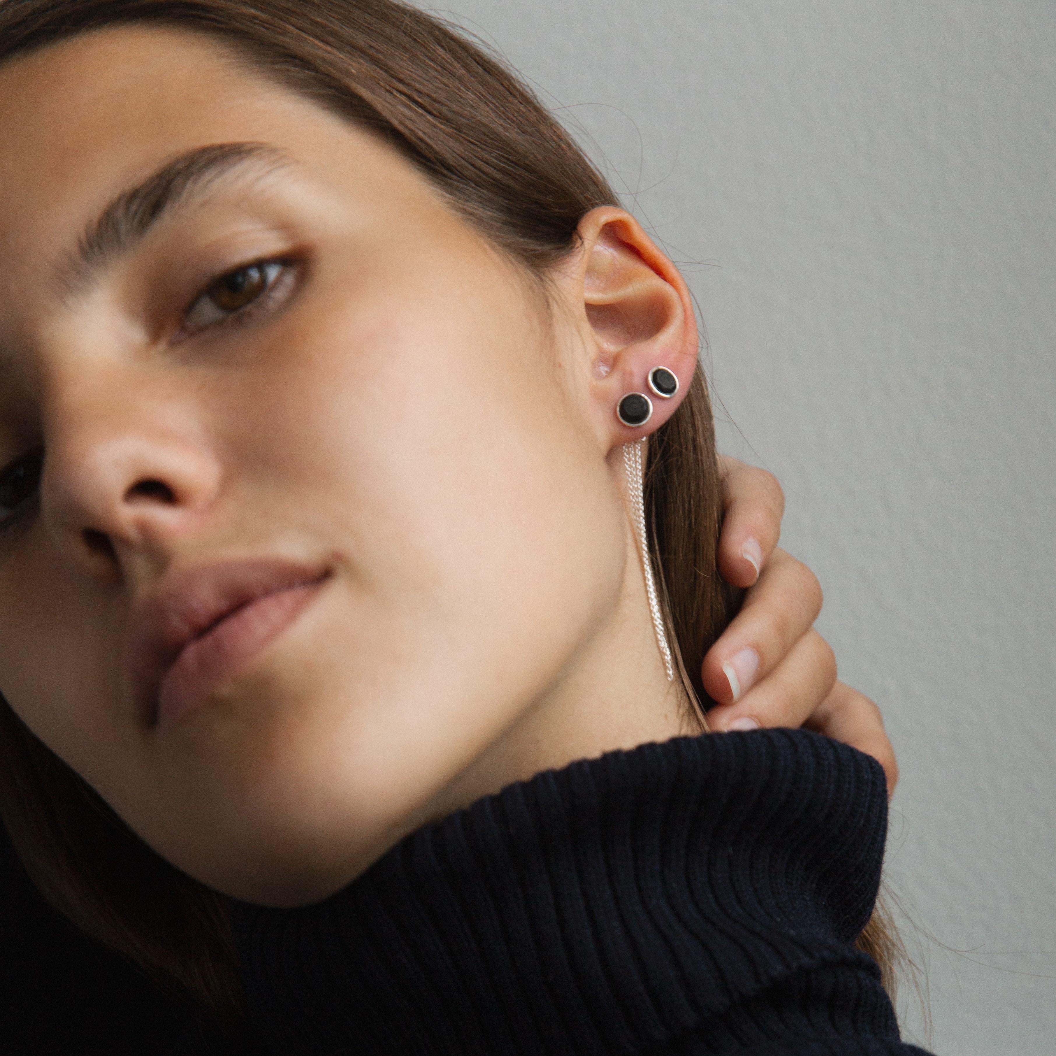 Also available in recycled 18k gold and as one piece earring.

A pair of I TASTE earrings in solid, recycled sterling silver. These lovely earrings are adorned with a sustainable, brilliant-cut Mpingo Blackwood diamond and three lively silver