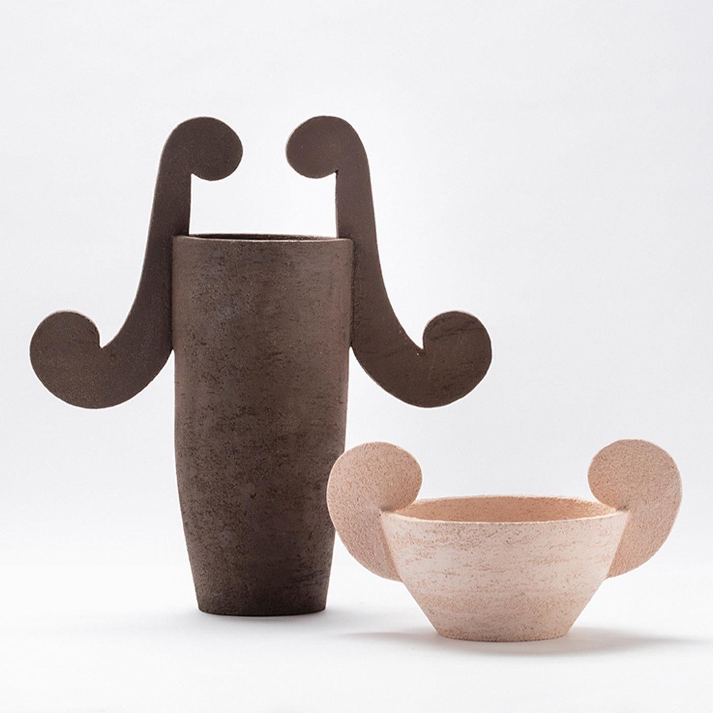 This exclusive vase massive is crafted by hand of demi-refractory terracotta and finished on a lathe. The vase embodies Ceo, god of the Intelligence, with its oxide brown hue. Decorative curls seal the pieces, which are fired at 1020°C.
