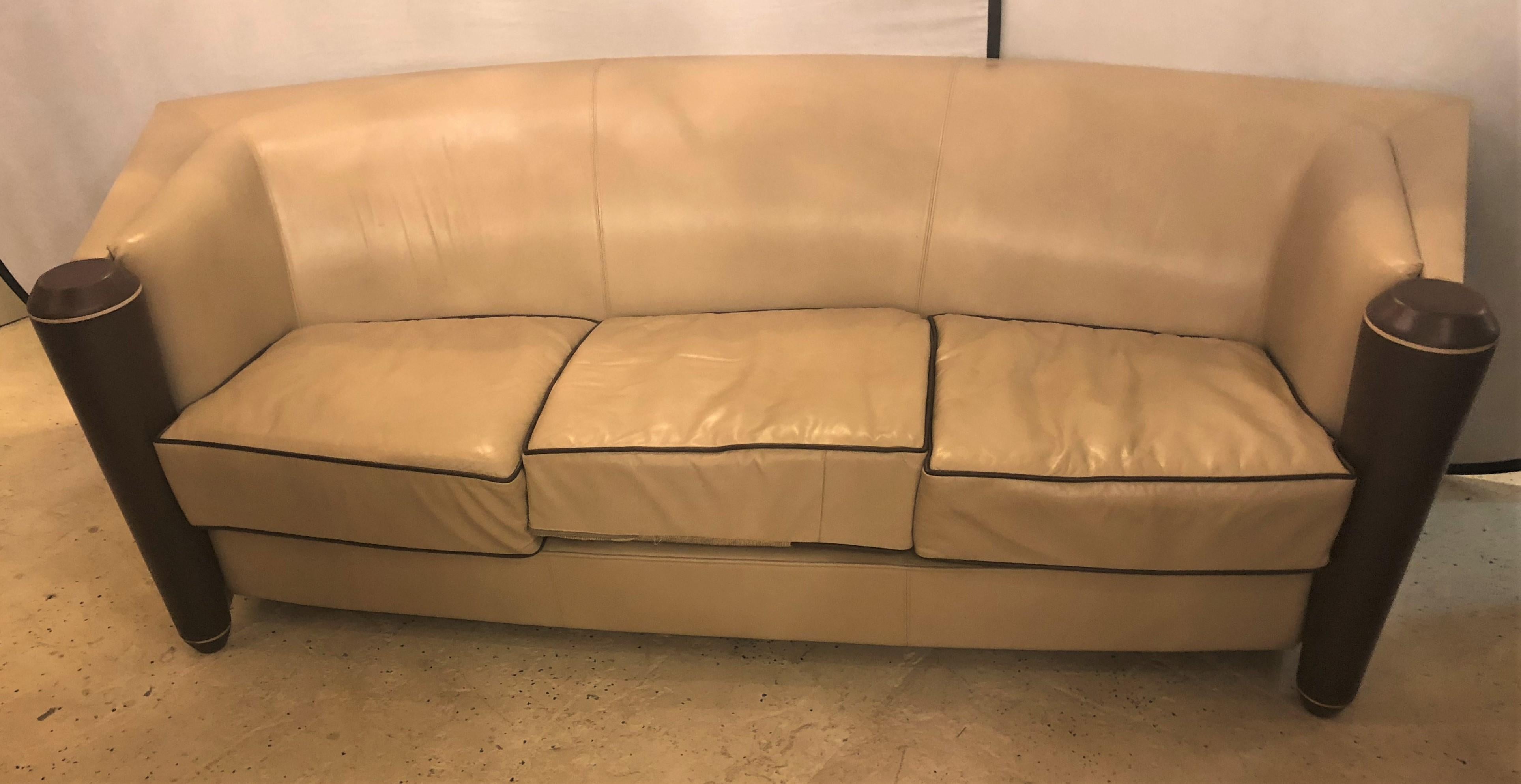 A beautiful three-seat i4 Marnie Sofa designed by Adam Tihany for the Pace Collection, Mariani Furniture. This sofa features a burr-elm back and tan leather upholstery with leather covered column-form sides. The frame is done in solid poplar and