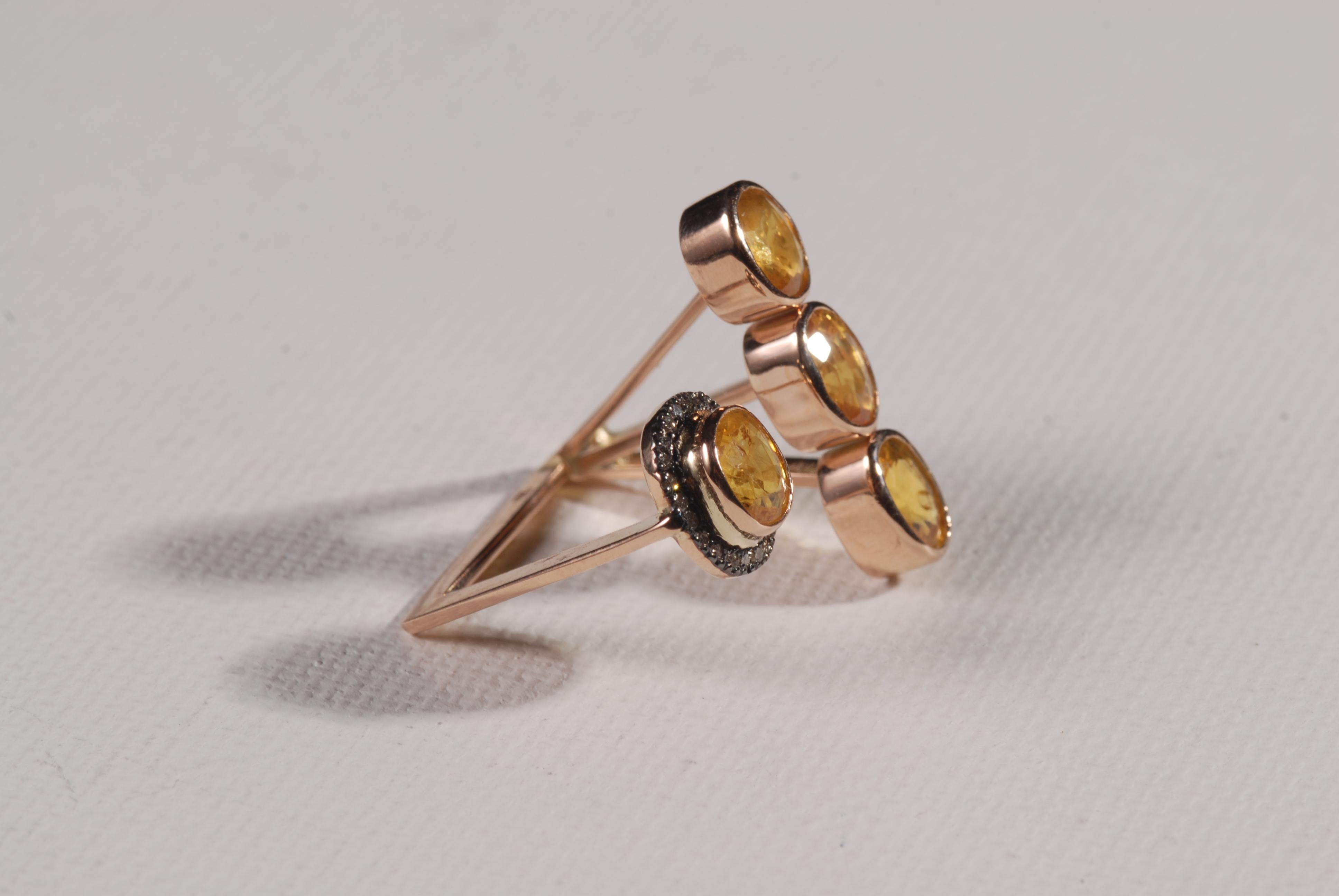 14 carat gold contemporary cocktail ring with yellow sapphires and diamonds.  