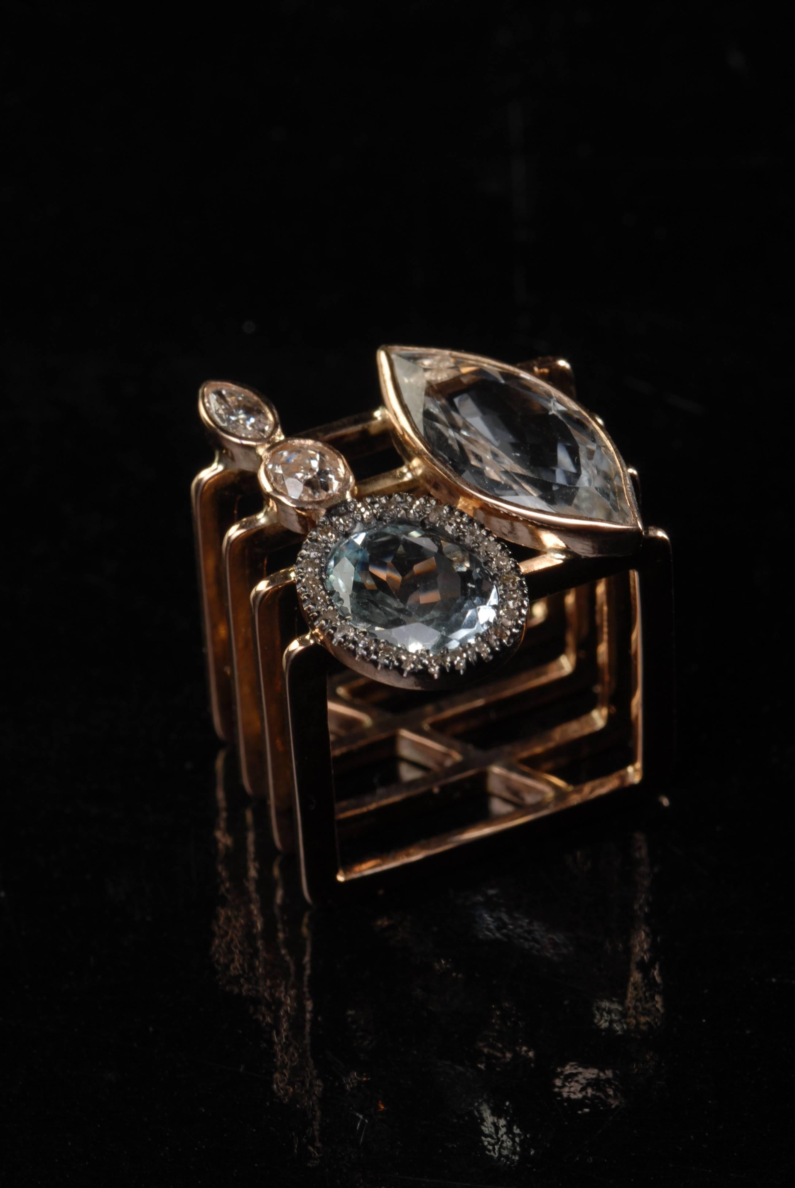 This handmade 14 carat rose-gold rectangular-shaped cocktail ring is made with two beautiful, faceted (marquise and oval)  light-color aquamarines and faceted, different-shape diamonds. 

Ring size US 7/UK N 

