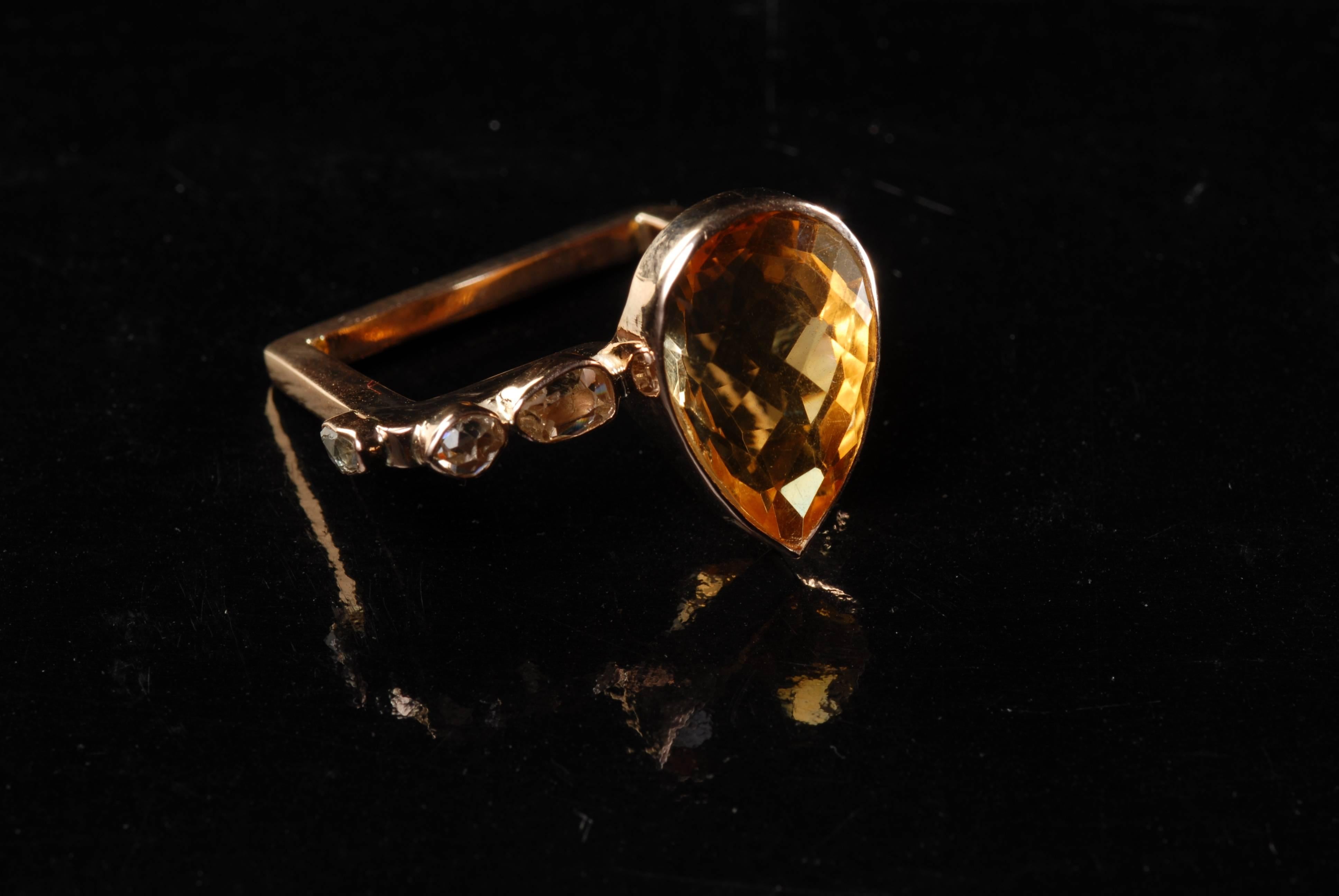 This geometric handmade 14-carat rose gold ring is made with gorgeous tear-drop yellow citrine, two uncut diamonds on the front, and one on the side. Recommended for the index finger. 

Size UK P/ US 8