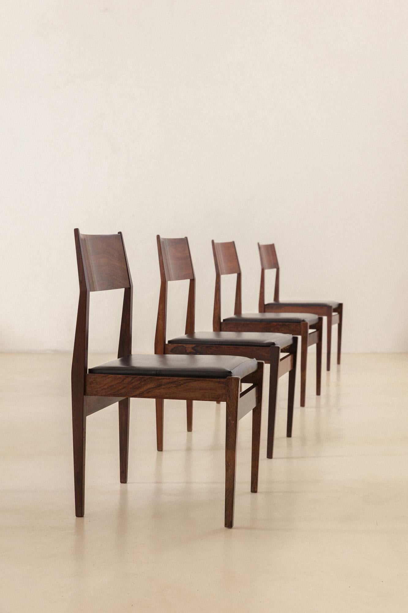 These chairs are made of Rosewood with leather seats and were produced c. 1960 by iadê. The pieces present rectangular profiles of solid Rosewood with large and comfortable seats and slightly leaning backrests in beautiful Rosewood veneers. 

iadê