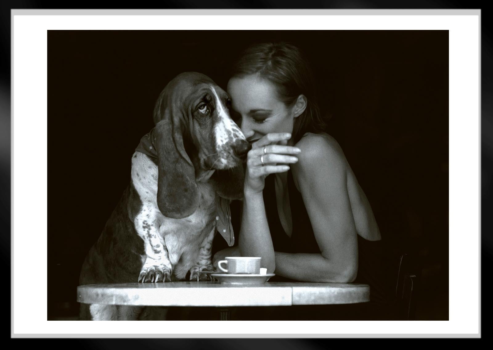  Banya  - Signed limited edition archival pigment print  - Edition of 2/5   
A Basset Hound with her friend in a French café

This image was captured on film in 1998. 
The negative was scanned creating a digital file which was then printed on