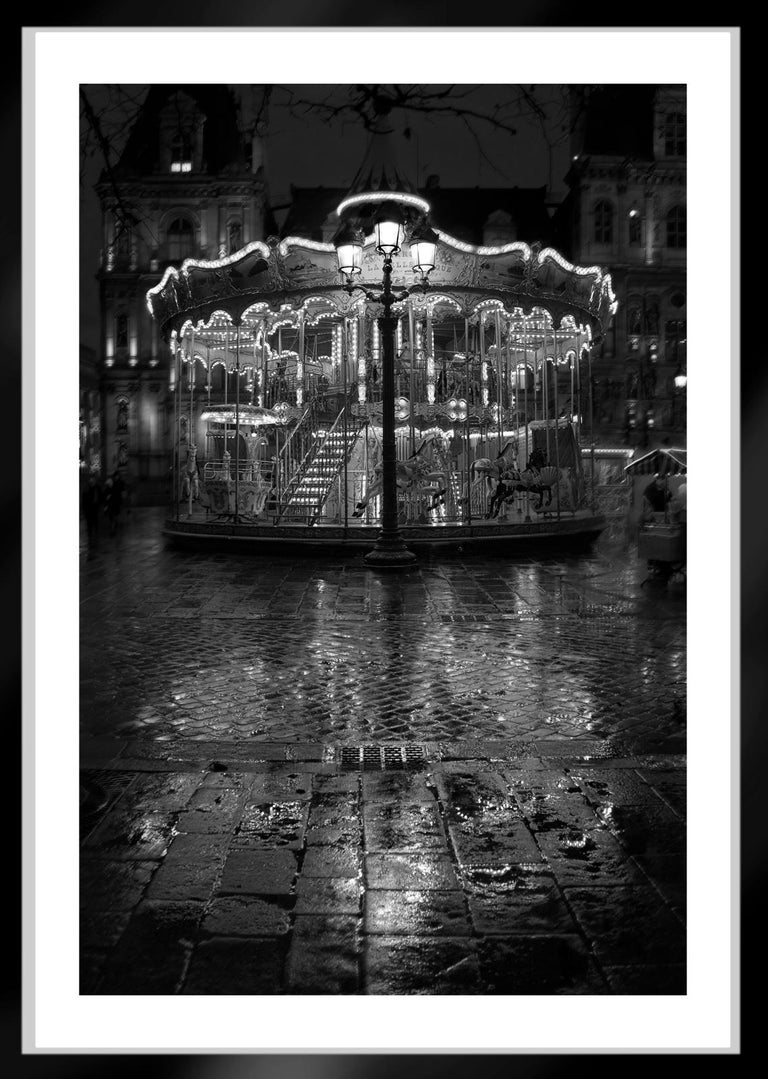 Carrousel   -   Signed limited edition archival pigment print, 2009  -   Edition of 10
Place de l'Hôtel de Ville in Paris , France

This is an Archival Pigment print on fiber based paper ( Hahnemühle Photo Rag® Baryta 315 gsm , Acid-free and