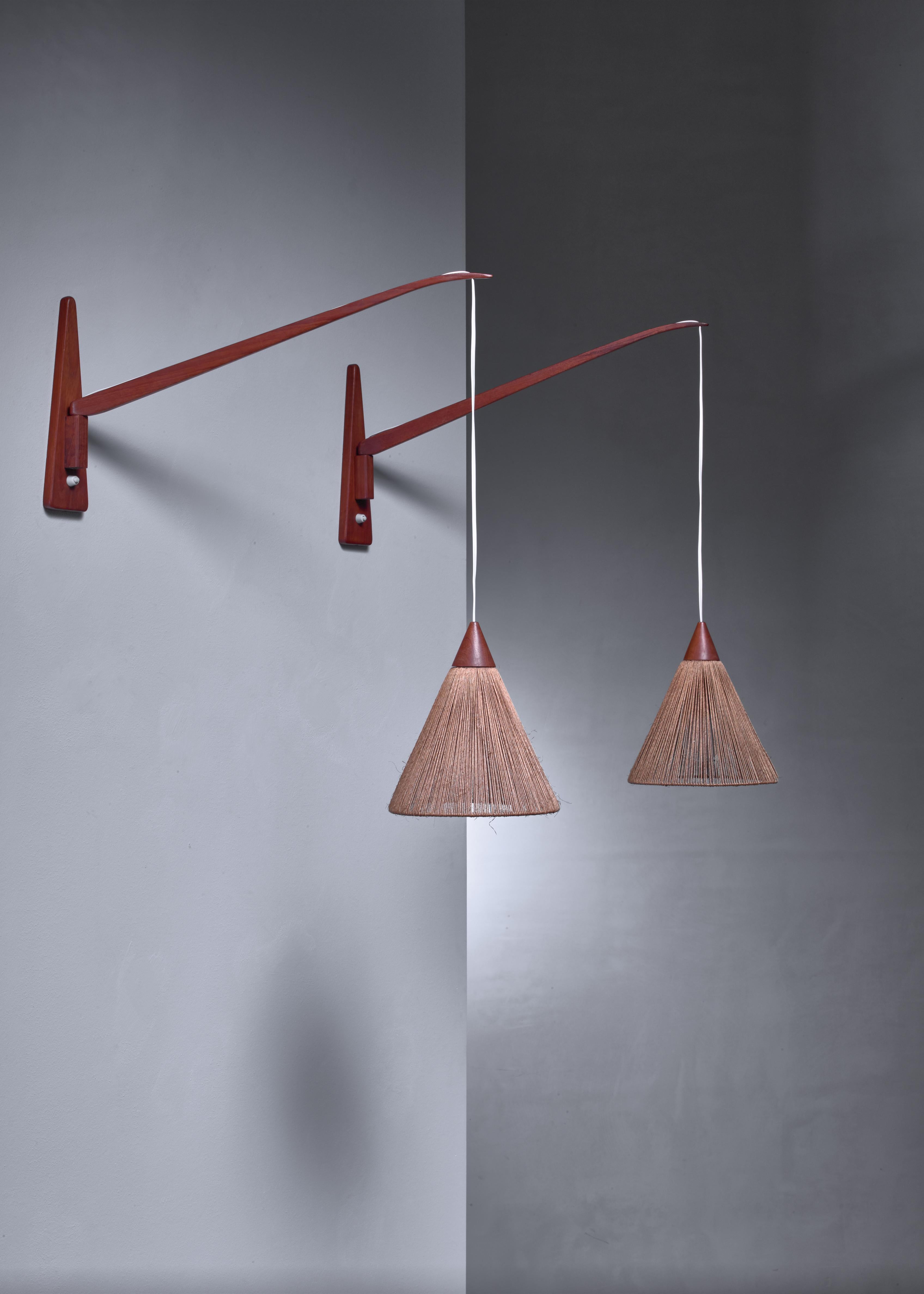 A pair of swiveling wall lamps attributed to Ib Fabiansen for Fog & Mørup, Denmark. The lamps are made of teak with a shade made of rope on a metal frame and cross over between bohemian and Scandinavian Modern.